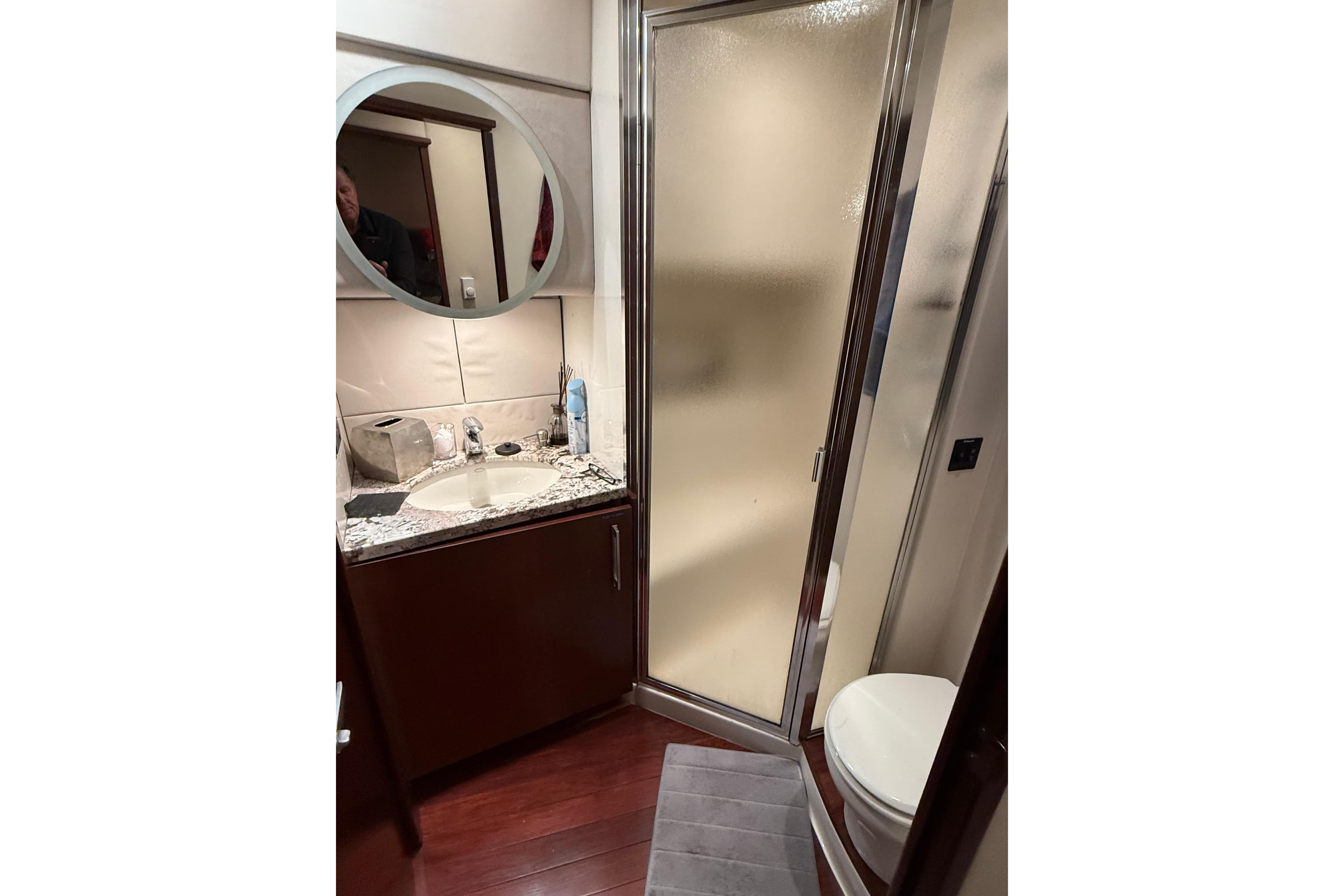 Bathroom interior of 1997 Bayliner 5788 Pilot House Motoryacht with shower and vanity.
