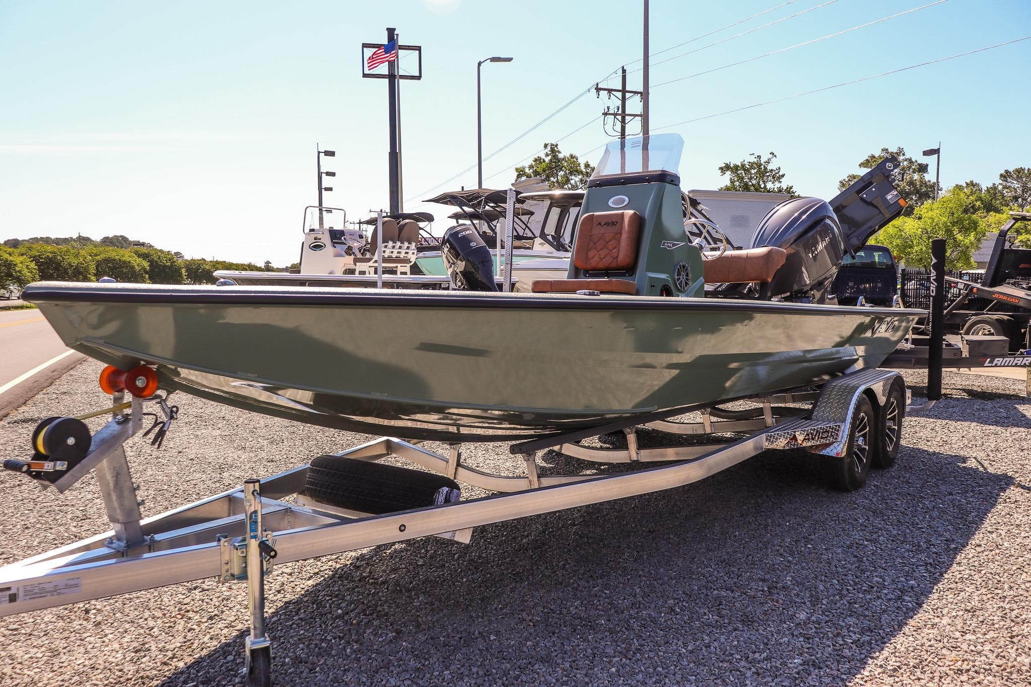 2026 Avid 21 FSX boat on trailer, displayed outdoors under clear sky.
