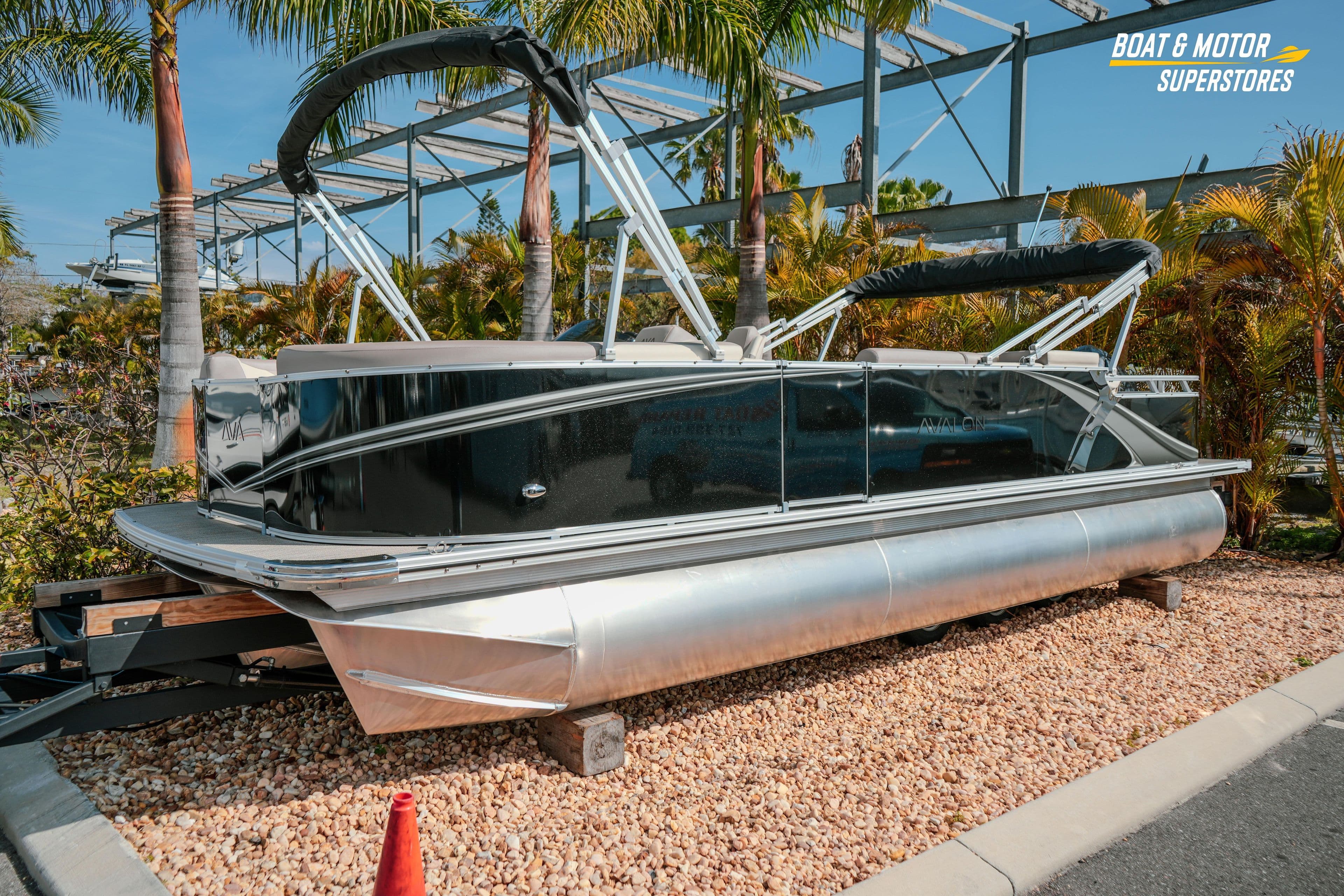2026 Avalon LSZ Rear Fish 23' pontoon boat displayed outdoors with palm trees.