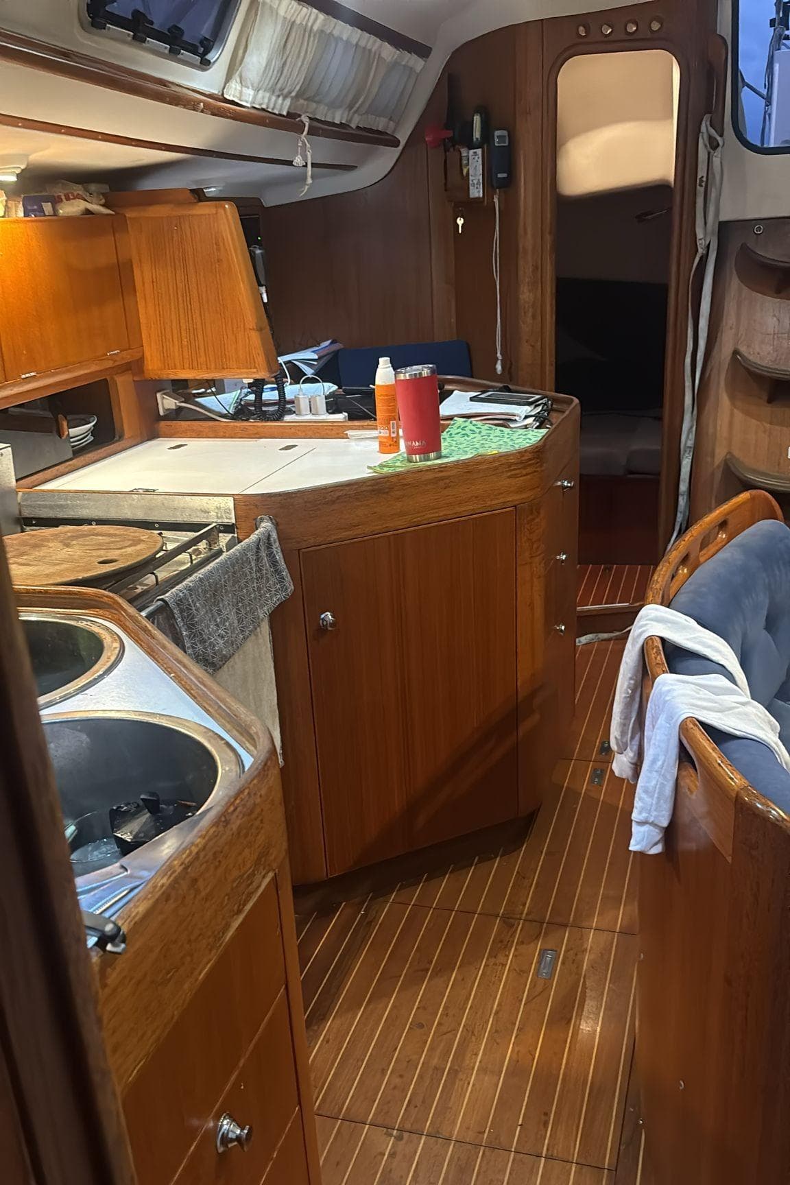 Interior of 2000 X-Yachts 442 MK II sailboat with wooden cabinetry and cozy layout.