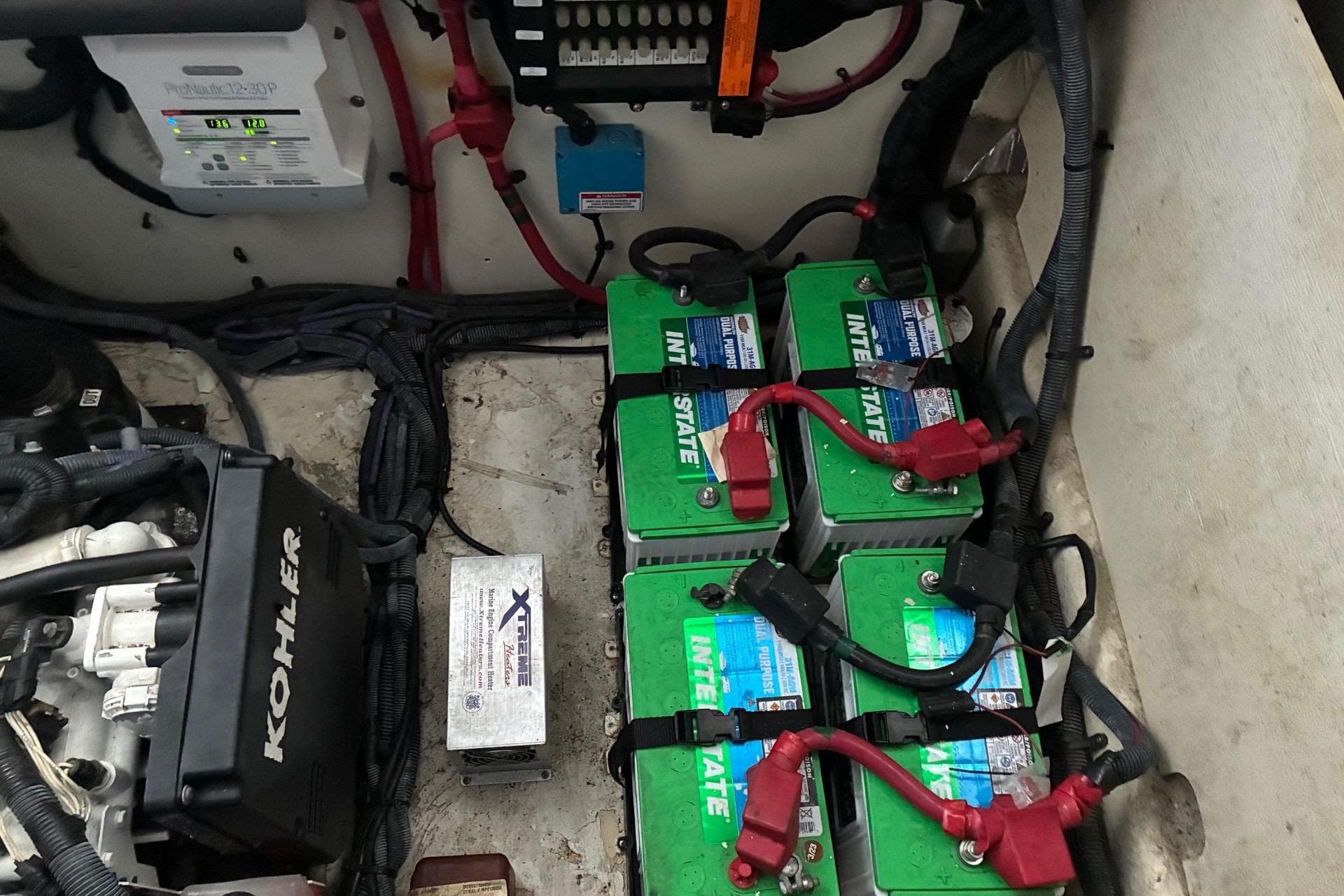 Engine compartment of 2010 Sea Ray 350 Sundancer with batteries and Kohler generator.