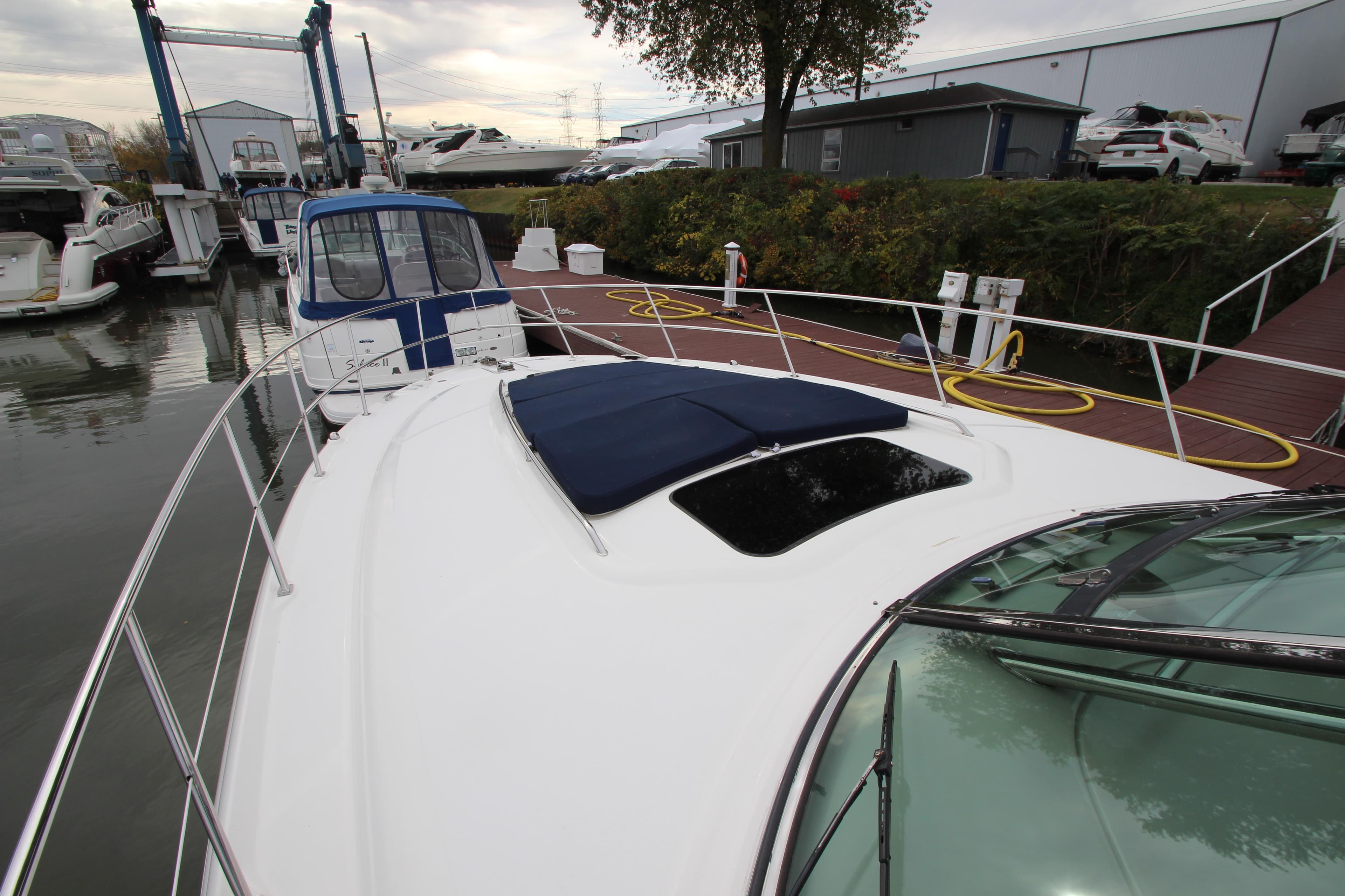 2007 Sea Ray 44 Sundancer yacht docked at marina with covered sunroof.
