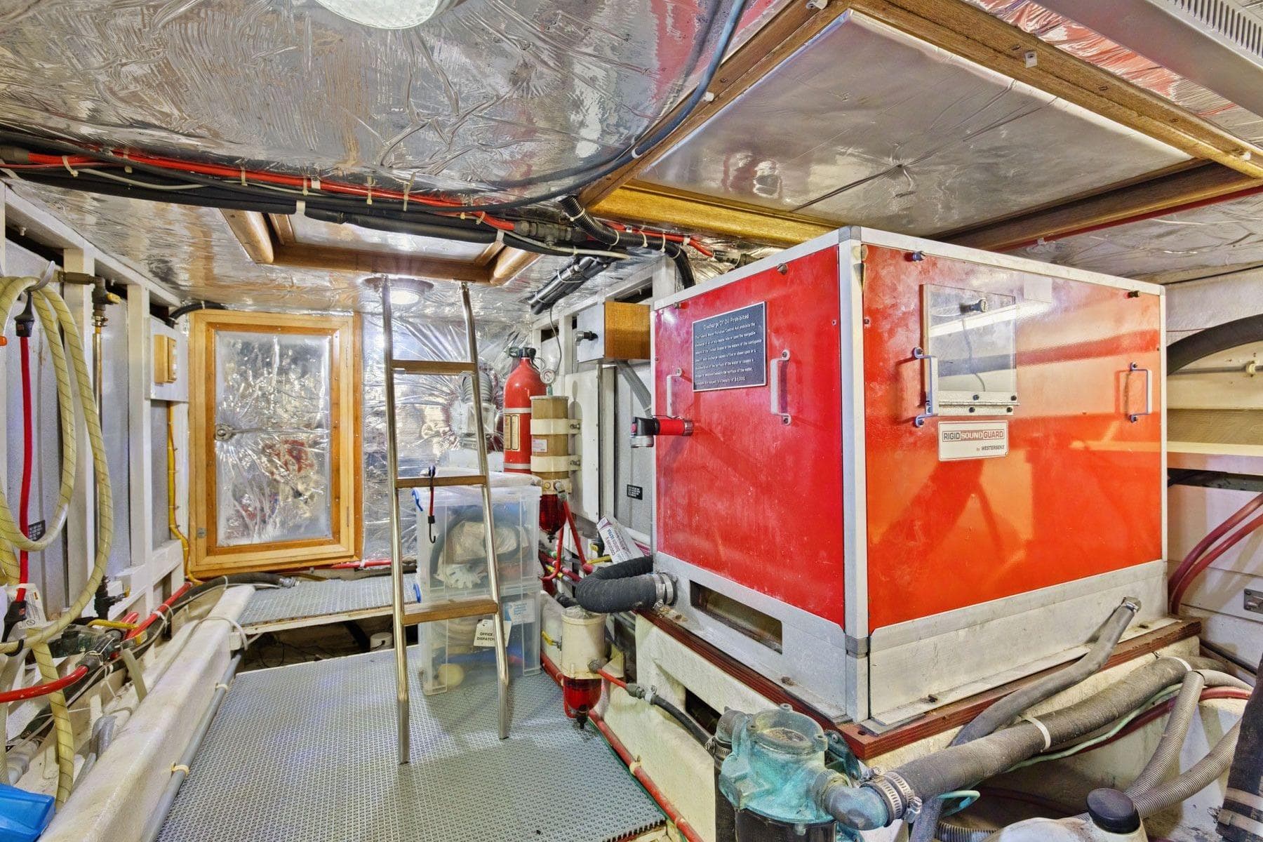 Engine room of 1991 Ocean Alexander 520 Pilothouse with equipment and ladder.