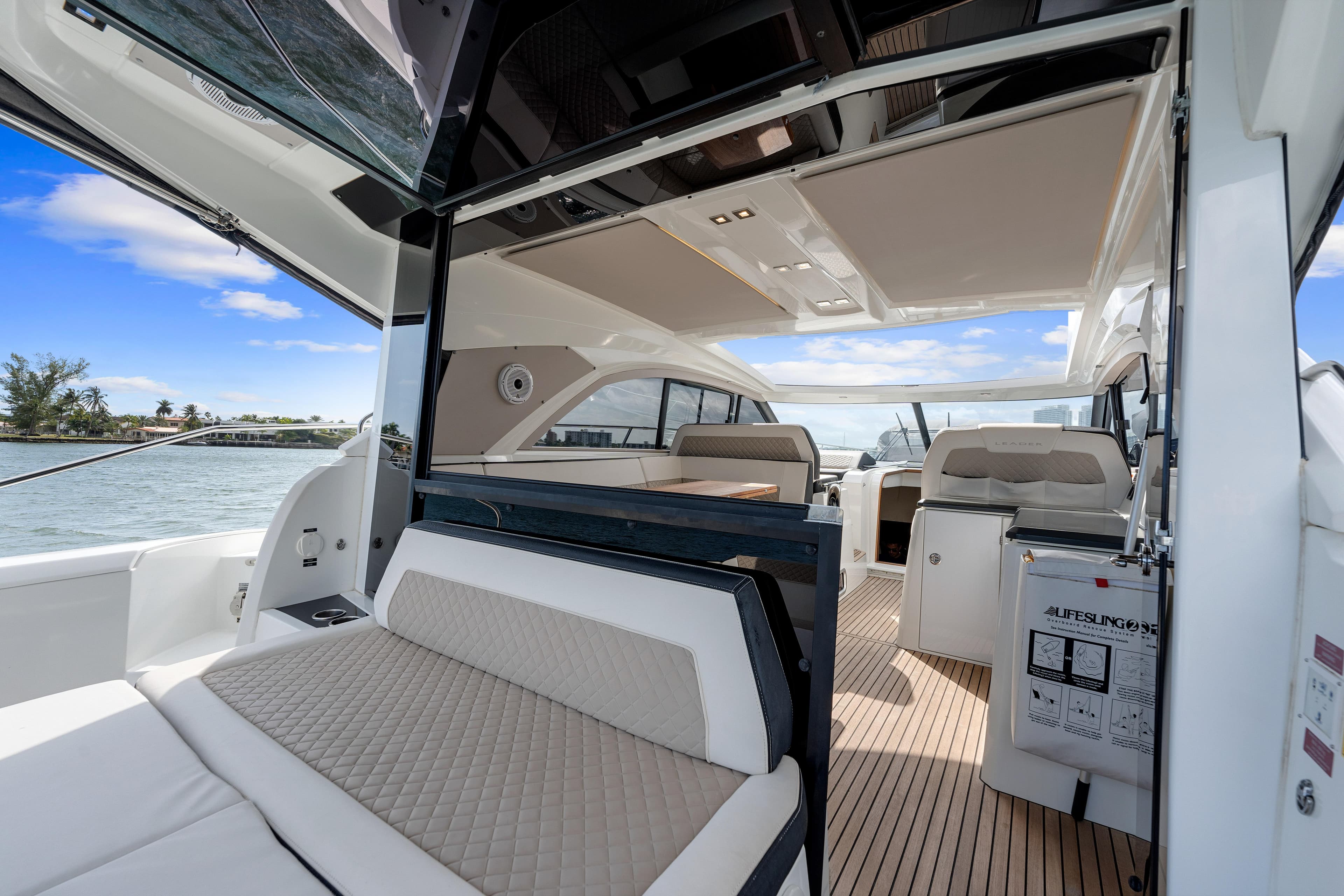 Luxurious 2018 Jeanneau Leader 46 yacht interior with elegant seating and open deck view.