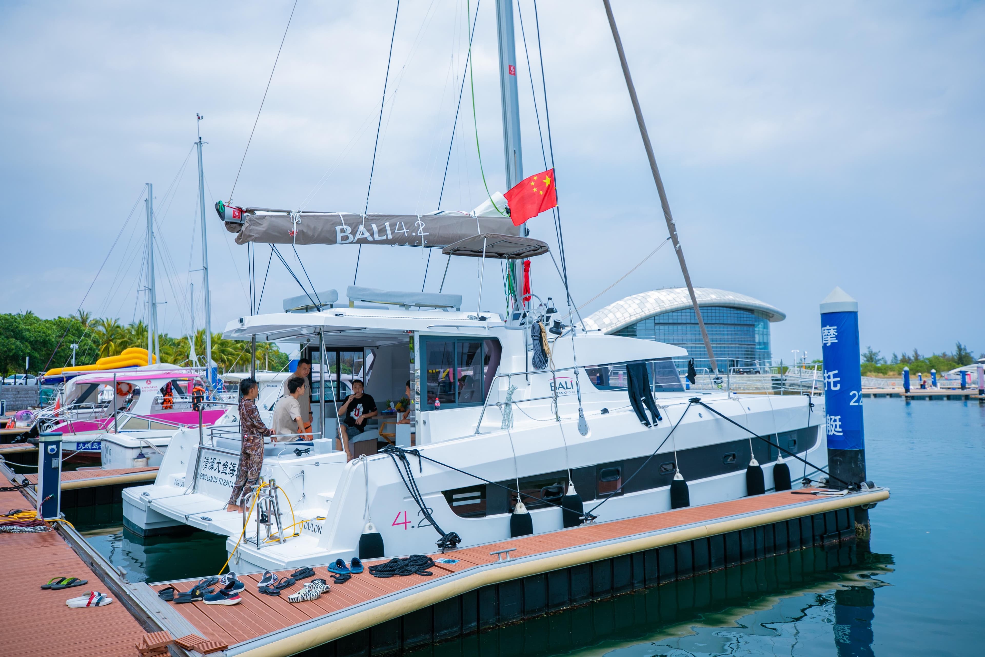 2021 Bali 4.2 catamaran docked at marina with people onboard.