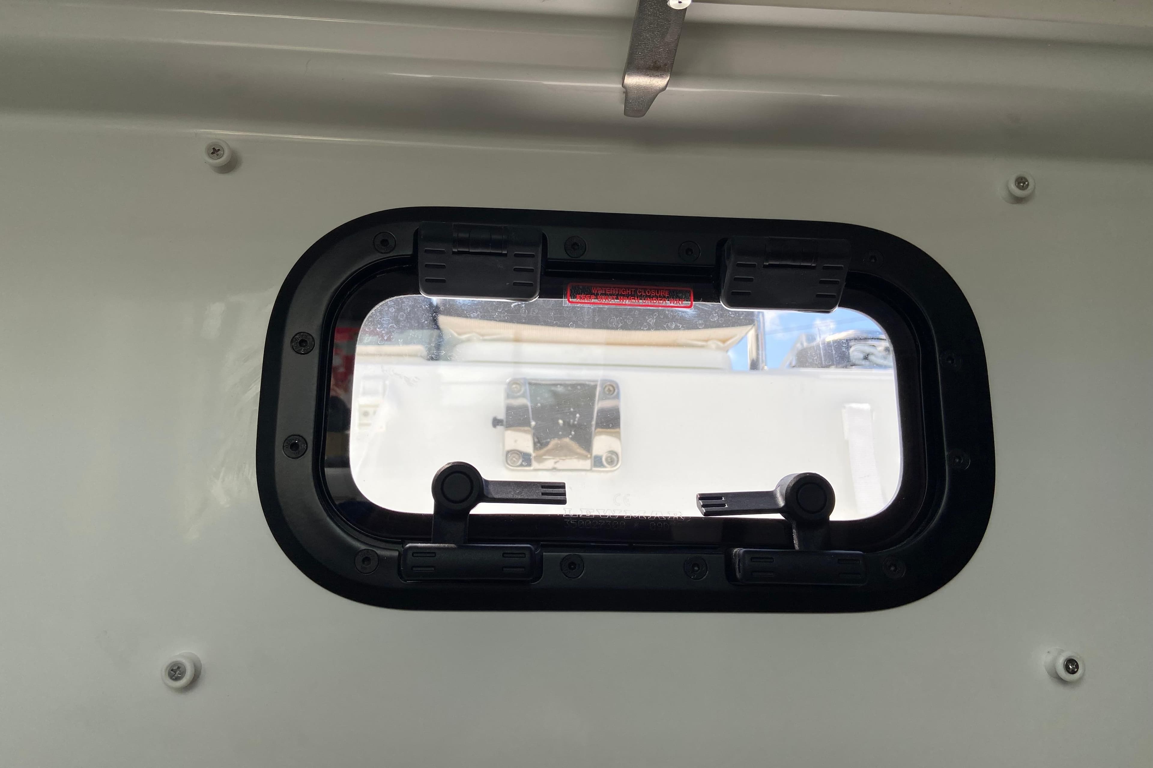 Porthole view from Jeanneau NC Sport 795 Series 2, 2026 model boat interior.