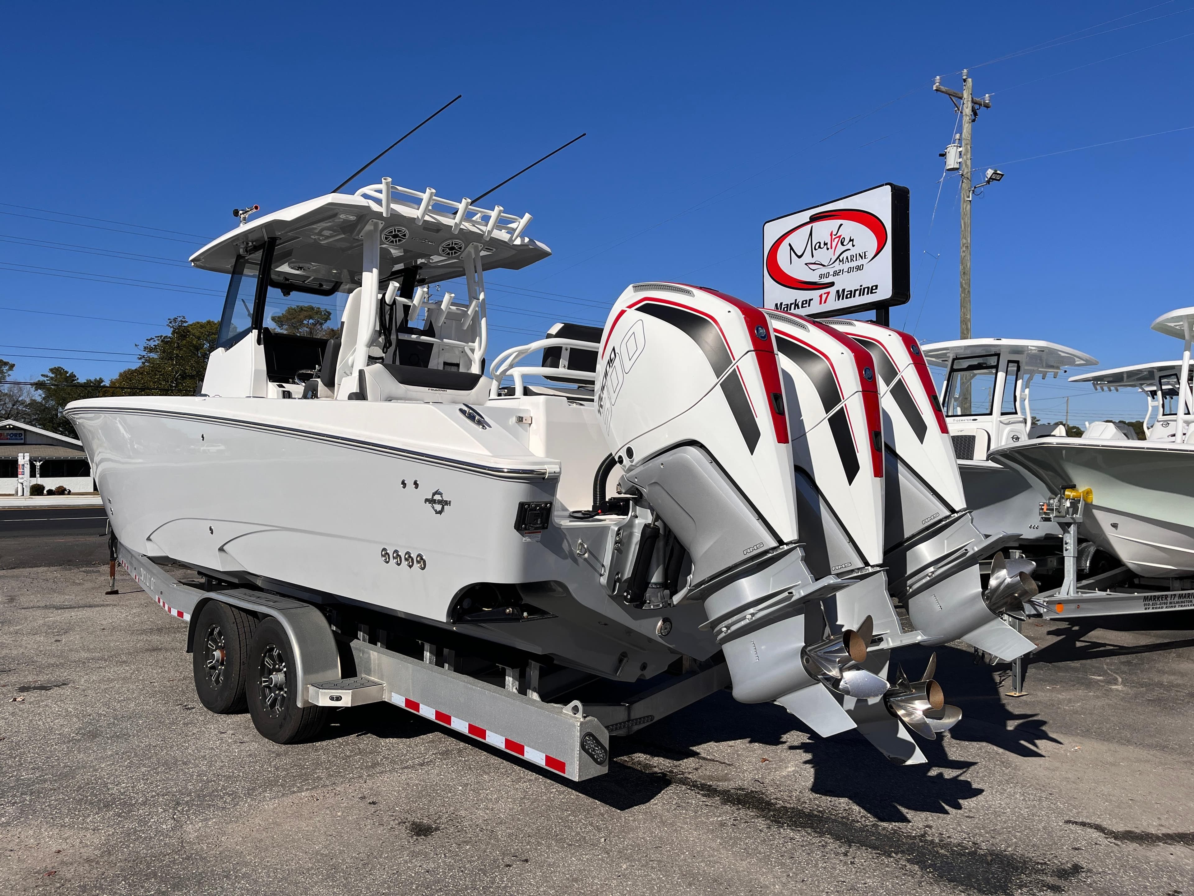 2023 Fountain 32 NX boat on trailer with dual outboard engines.