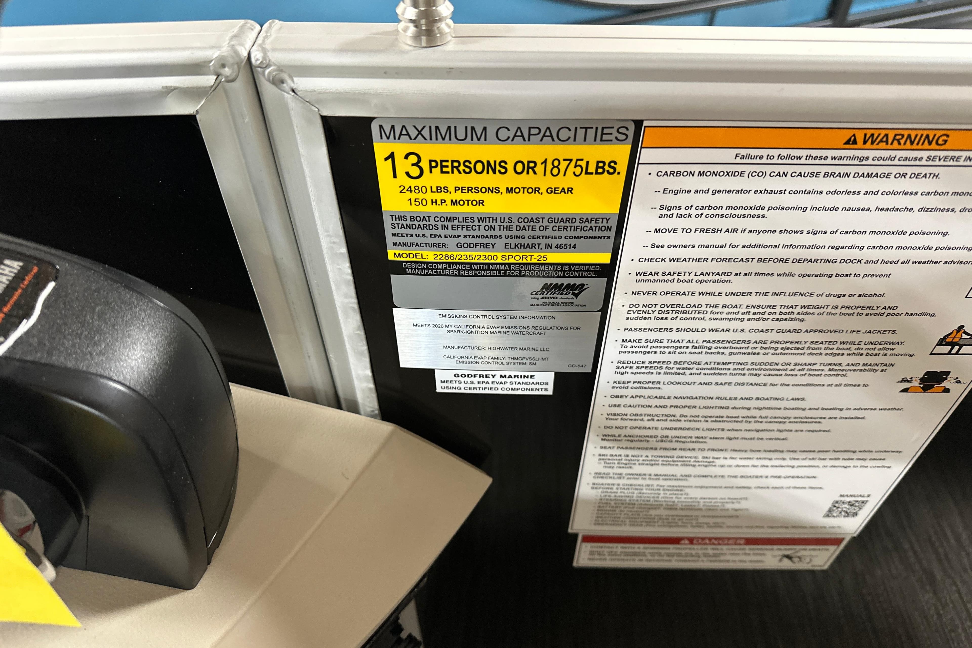 Capacity and safety warnings on 2026 Godfrey SWEETWATER 2286 SB boat, highlighting weight and passenger limits.