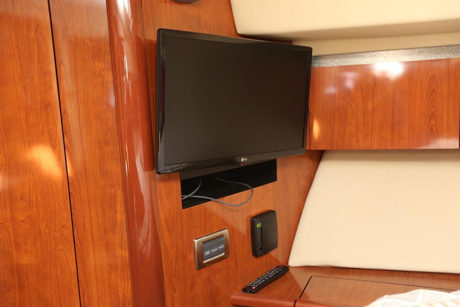 2004 Sea Ray 420 Sedan Bridge interior with mounted TV and wooden paneling.
