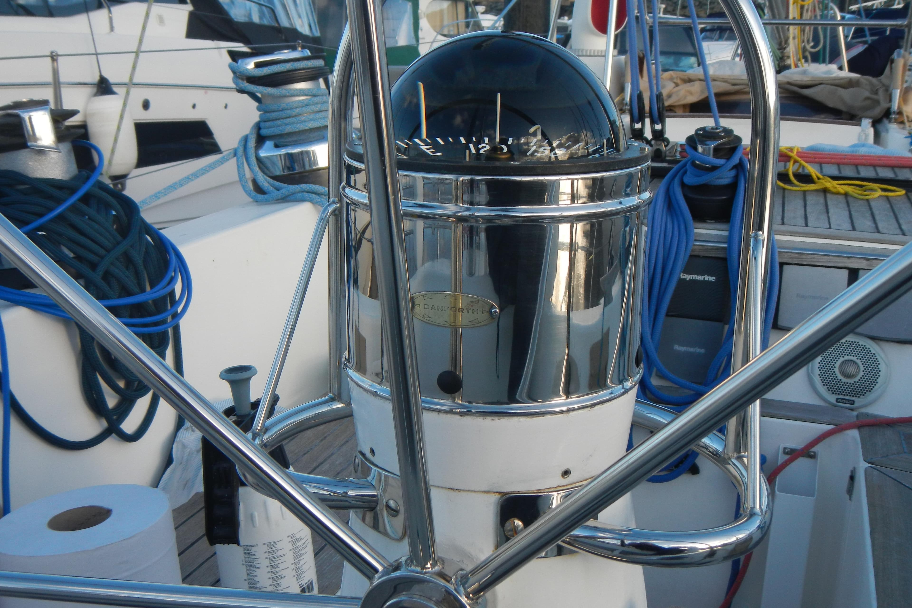 Steering wheel and compass on a 1980 Nautor Swan 411 sailboat deck.