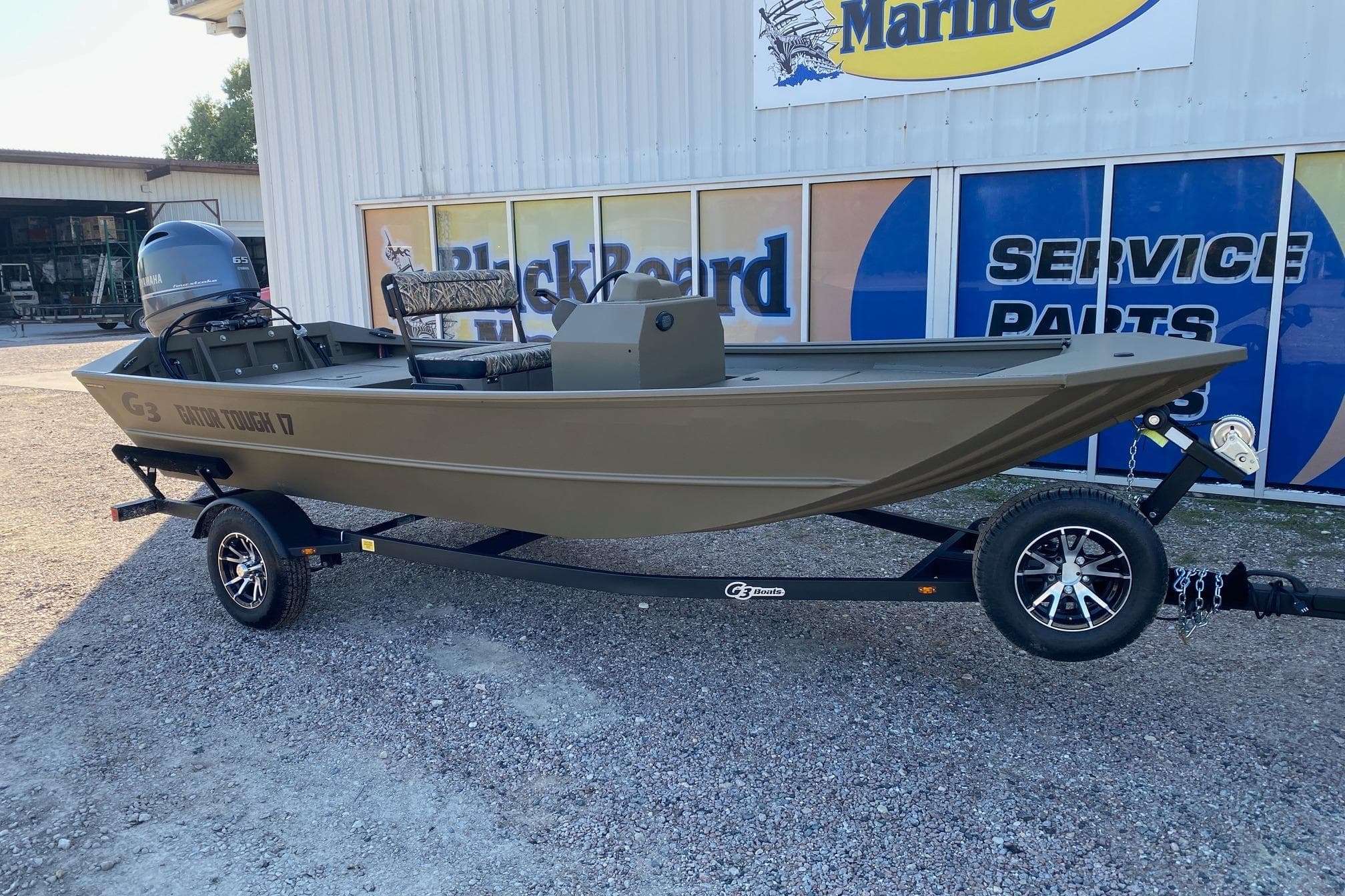 2026 G3 Gator Tough 17 CCJ boat on trailer outside marine service shop.