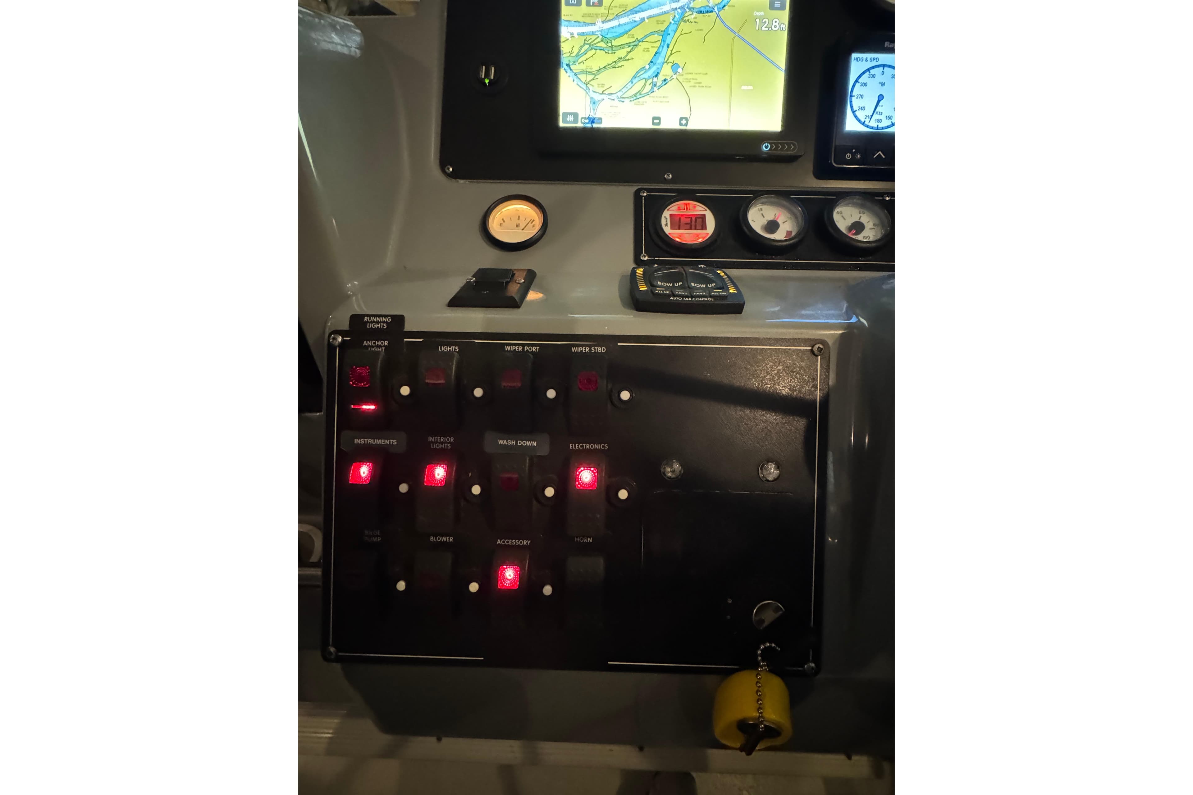Control panel of a 2006 Monaro 27 SE/SX with illuminated switches and navigation display.