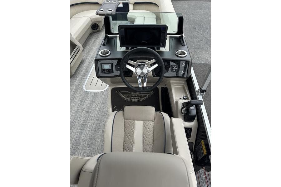 2026 Bennington M Swingback 24 MSB boat interior with modern steering and dashboard controls.