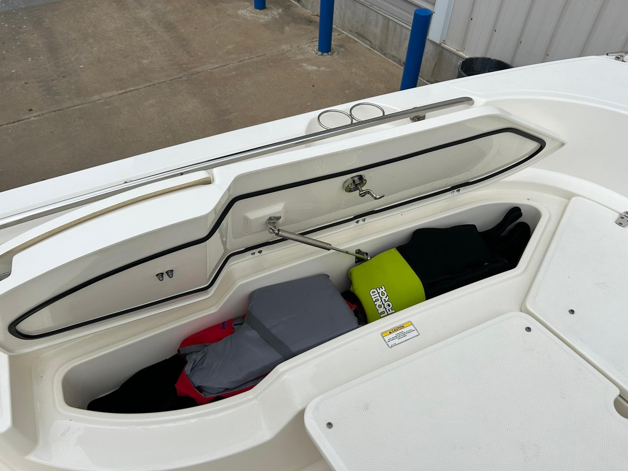 2017 Boston Whaler 270 Dauntless storage compartment with life jackets and gear.