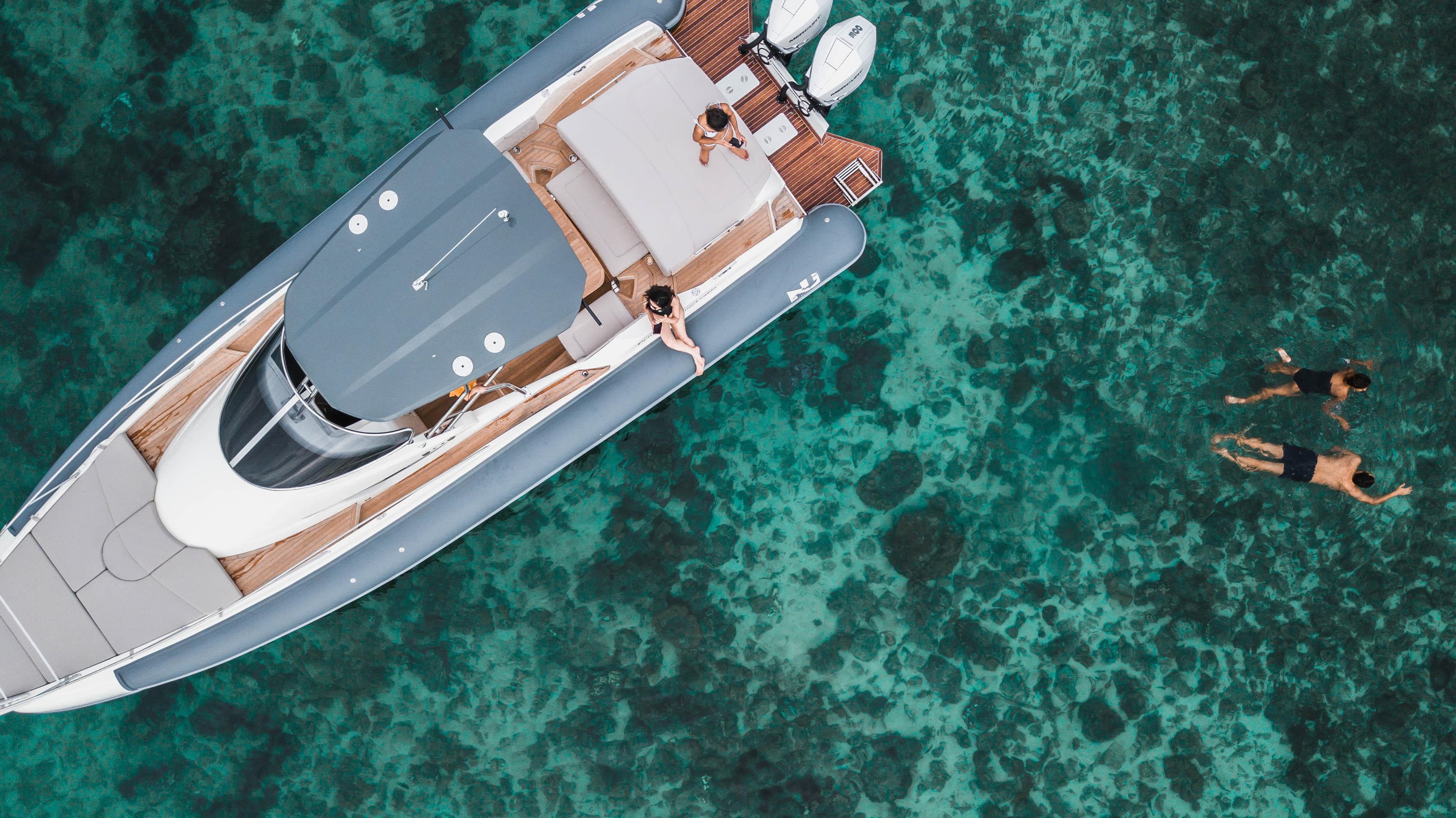 Aerial view of 2020 Nuova Jolly Prince 38 yacht with swimmers in clear turquoise water.