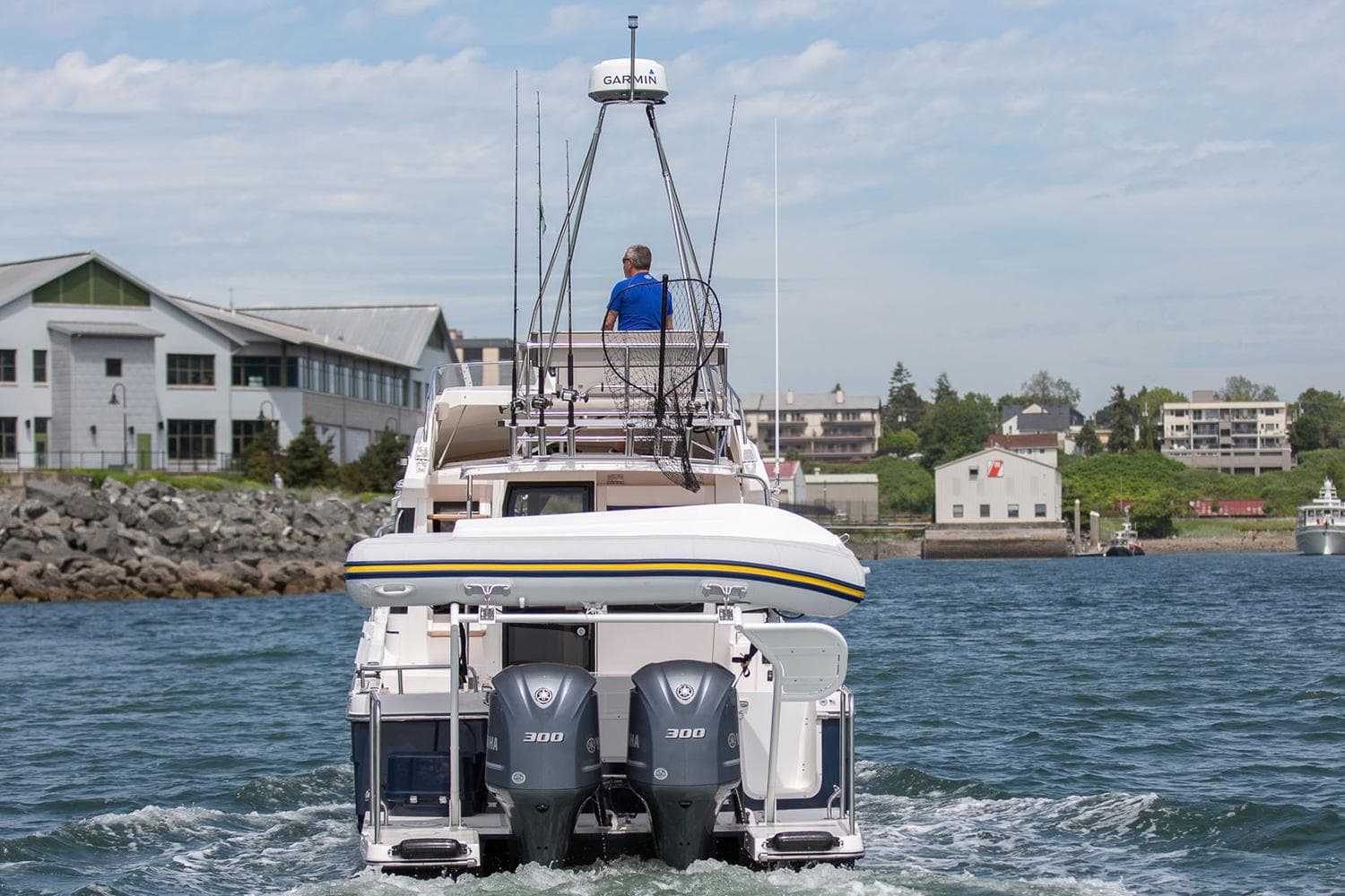 Manufacturer Provided Image: 2025 Cutwater C-32 CB boat cruising in a harbor with dual engines.