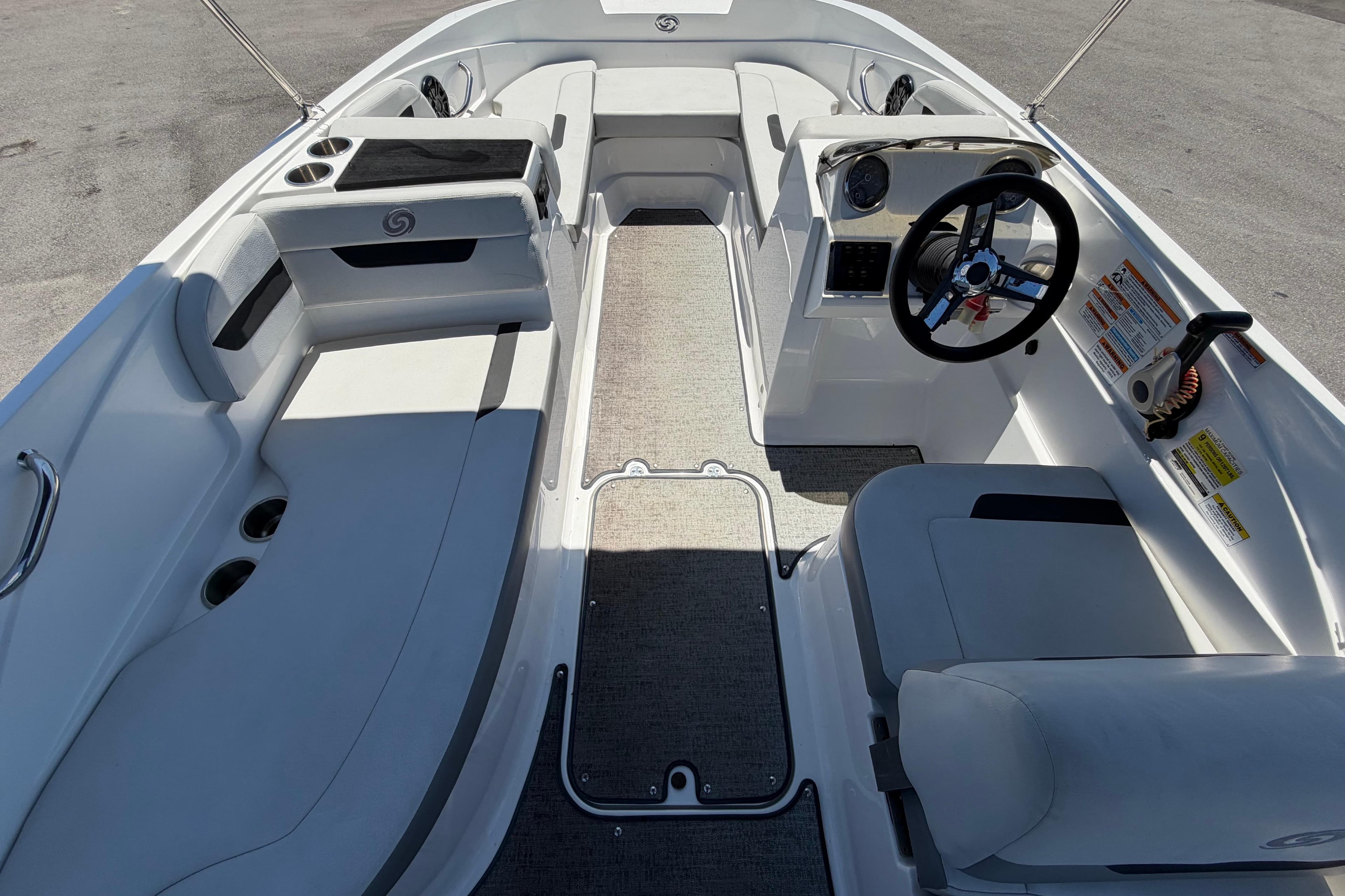 2022 Hurricane SunDeck Sport 185 OB boat interior with seating and steering wheel.
