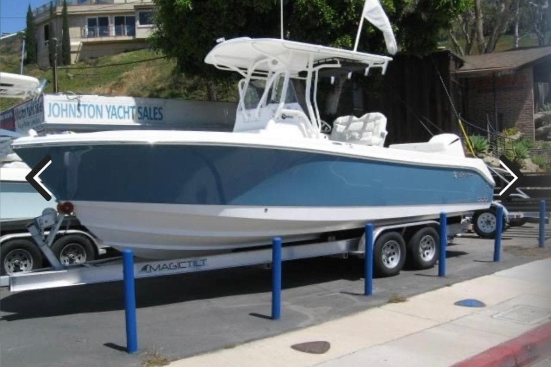 2023 Edgewater 245CC boat on trailer at yacht sales location.