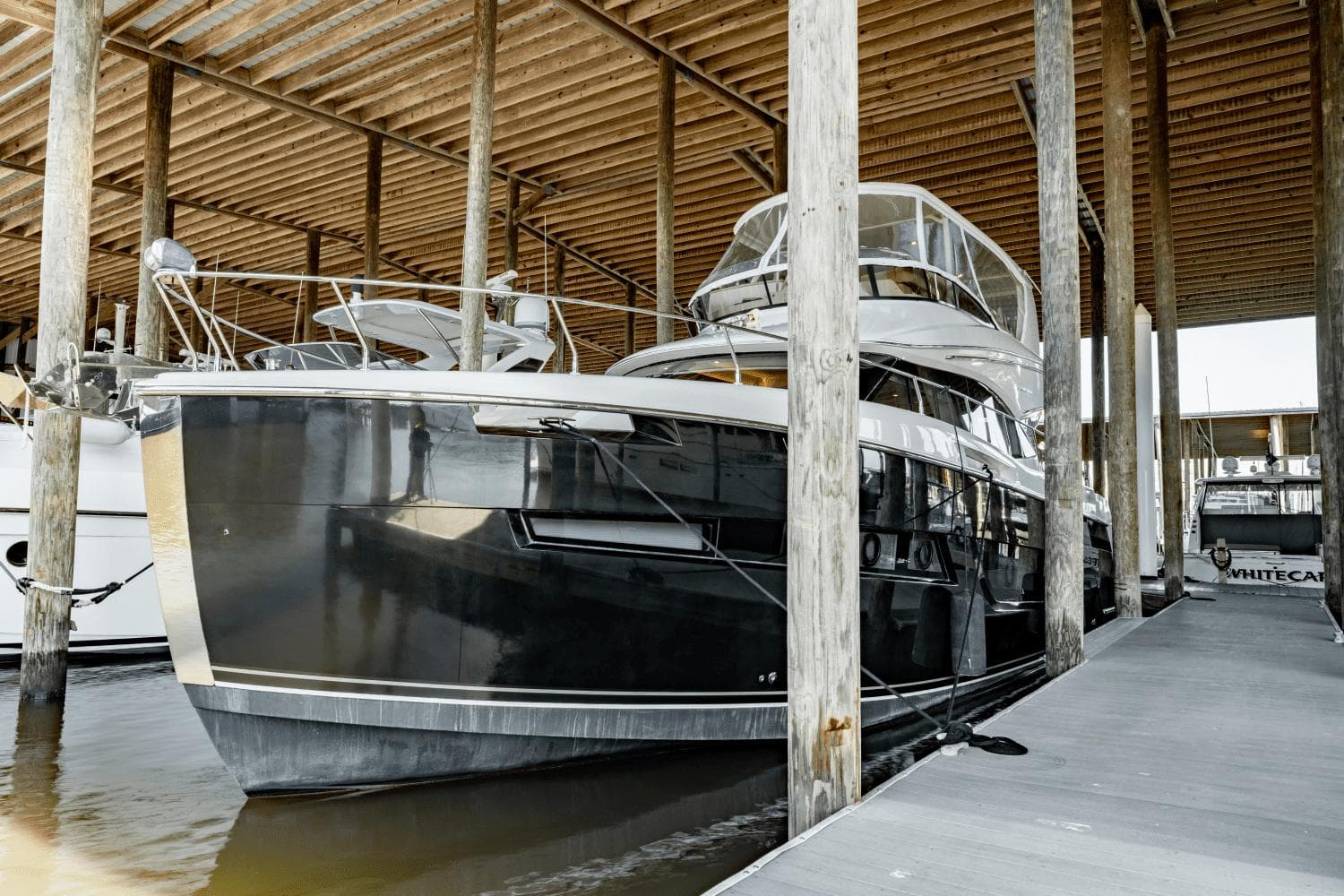 2017 Carver 52 Command Bridge yacht docked in a covered marina.