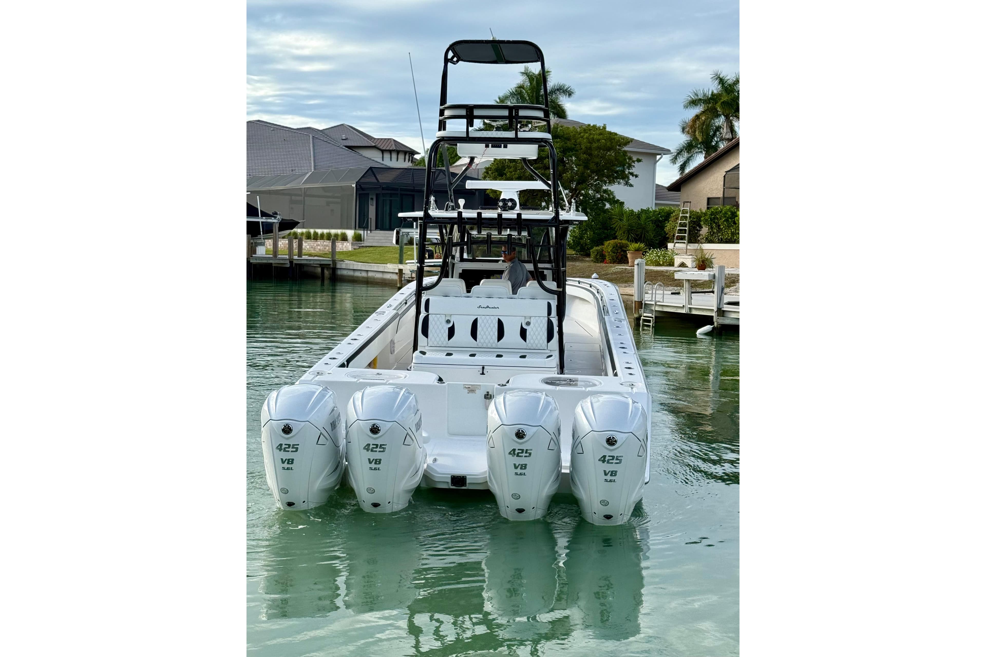 2020 SeaHunter 41 CTS boat with four powerful 425 V8 engines docked in a serene marina.