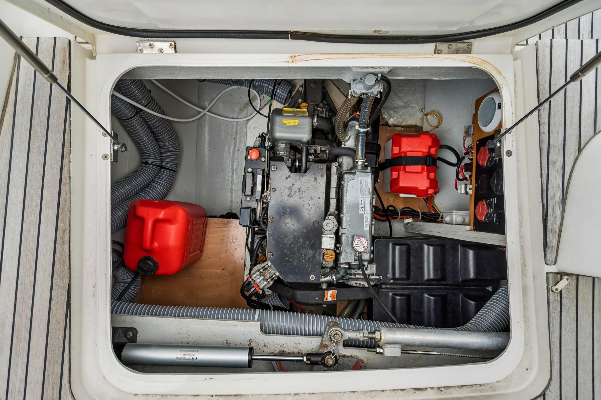 Engine compartment of a 2017 Lagoon 42 catamaran, featuring mechanical components and storage.