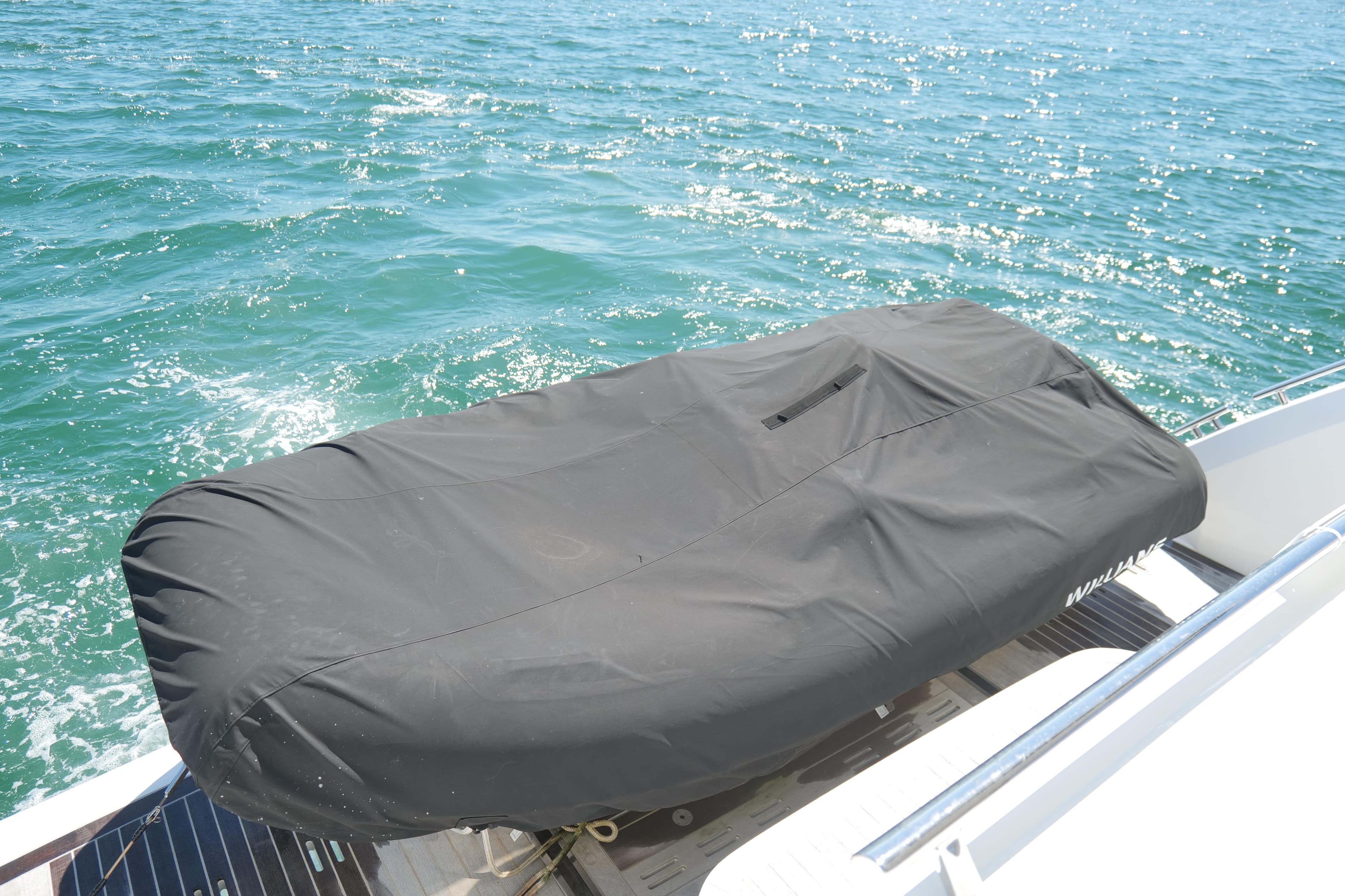 Covered Pearl 62 boat on water, 2022 model, with black protective cover.