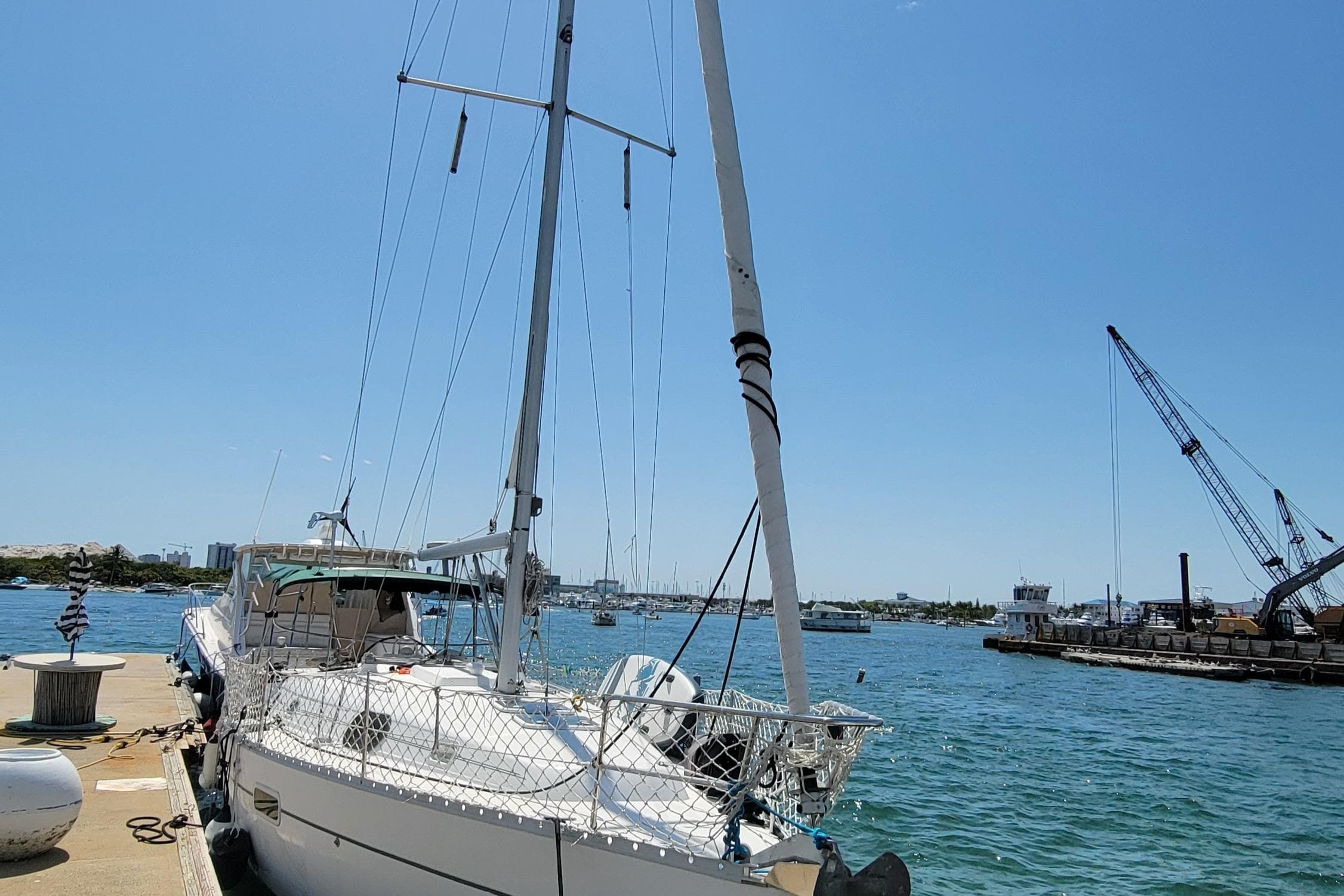 2002 Beneteau Oceanis Clipper 361 sailboat docked at a sunny marina.