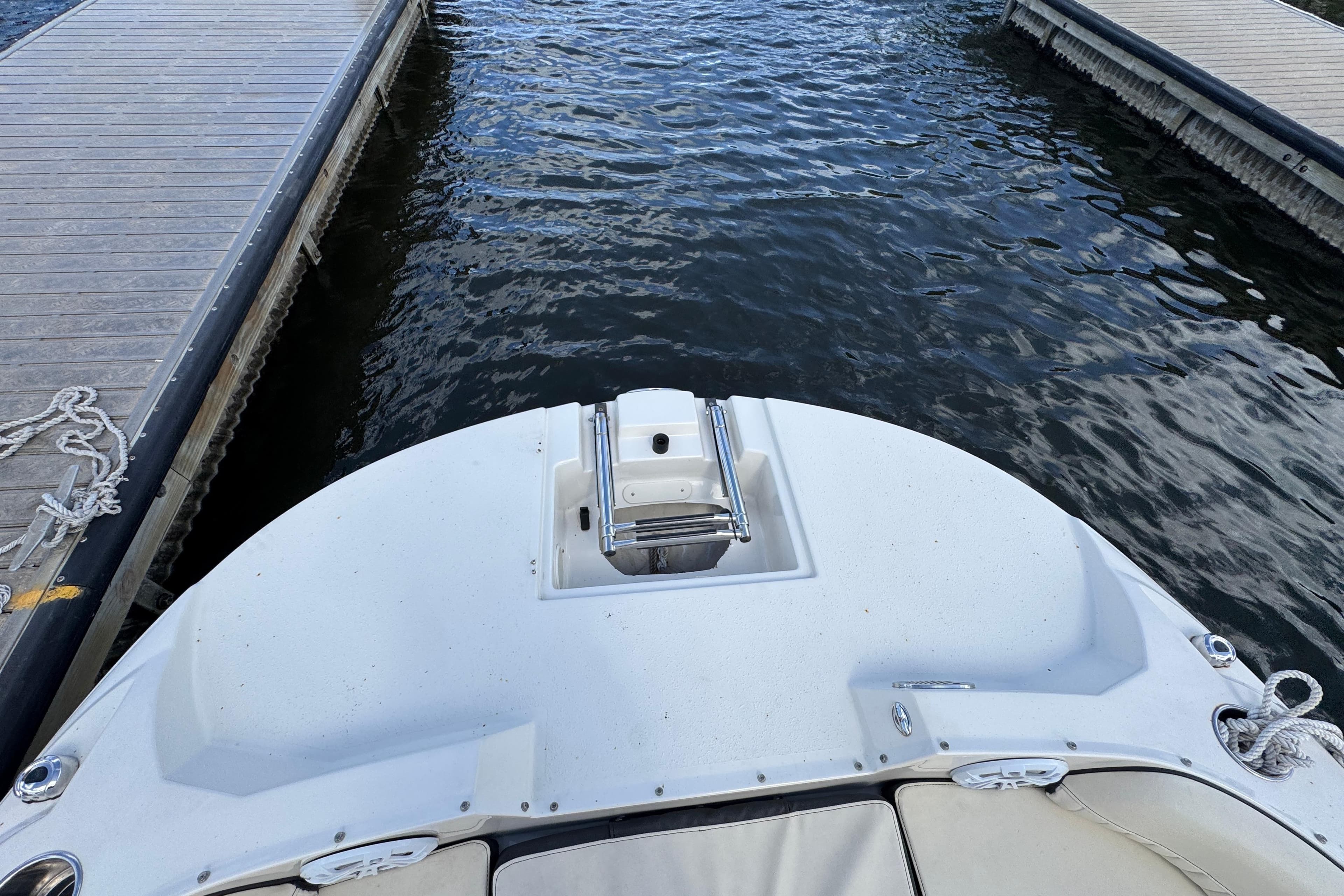 2022 Stingray 192 SC boat docked between piers on calm water.