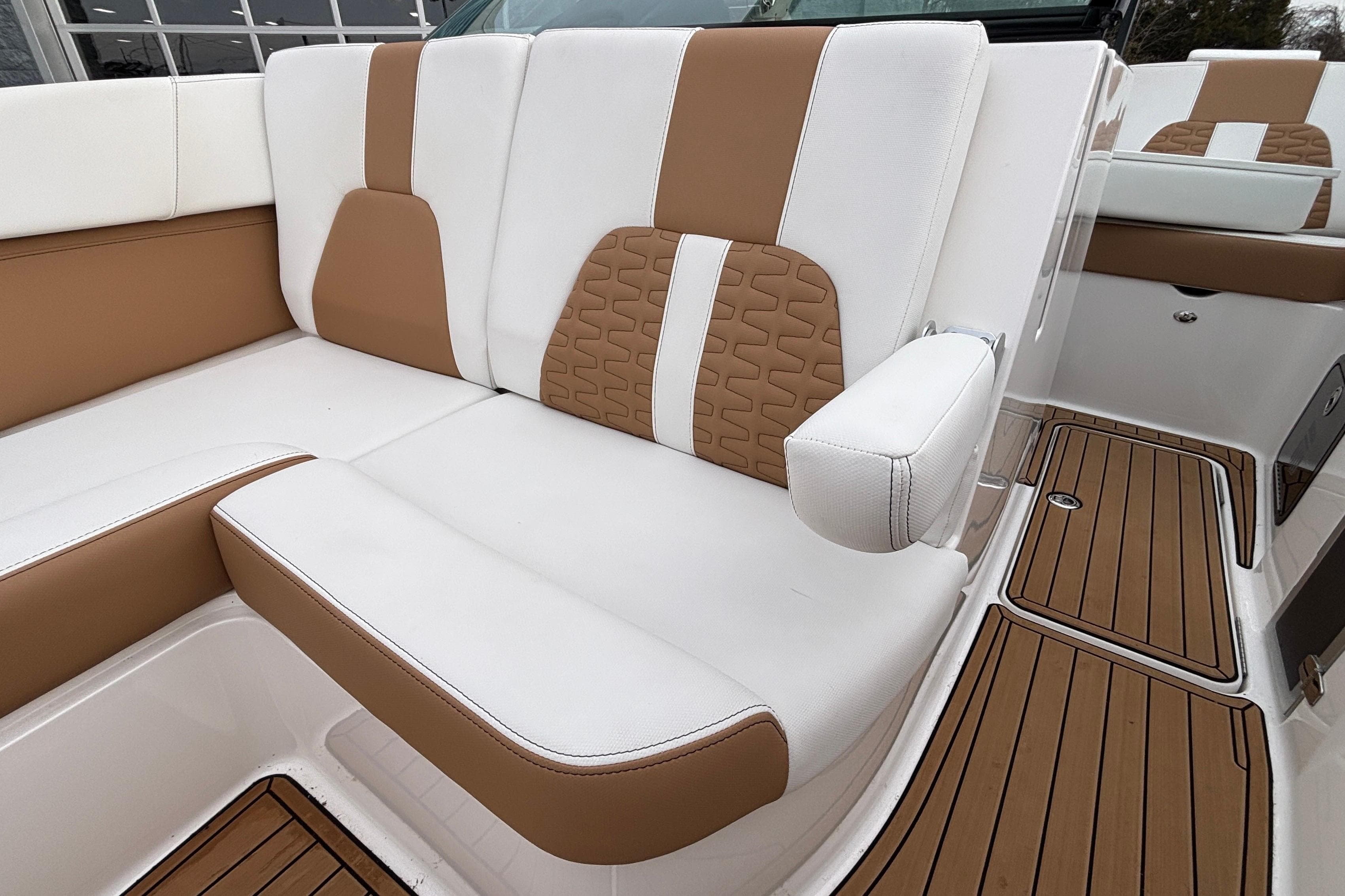 2022 MasterCraft X26 boat interior with white and tan seating, teak flooring.