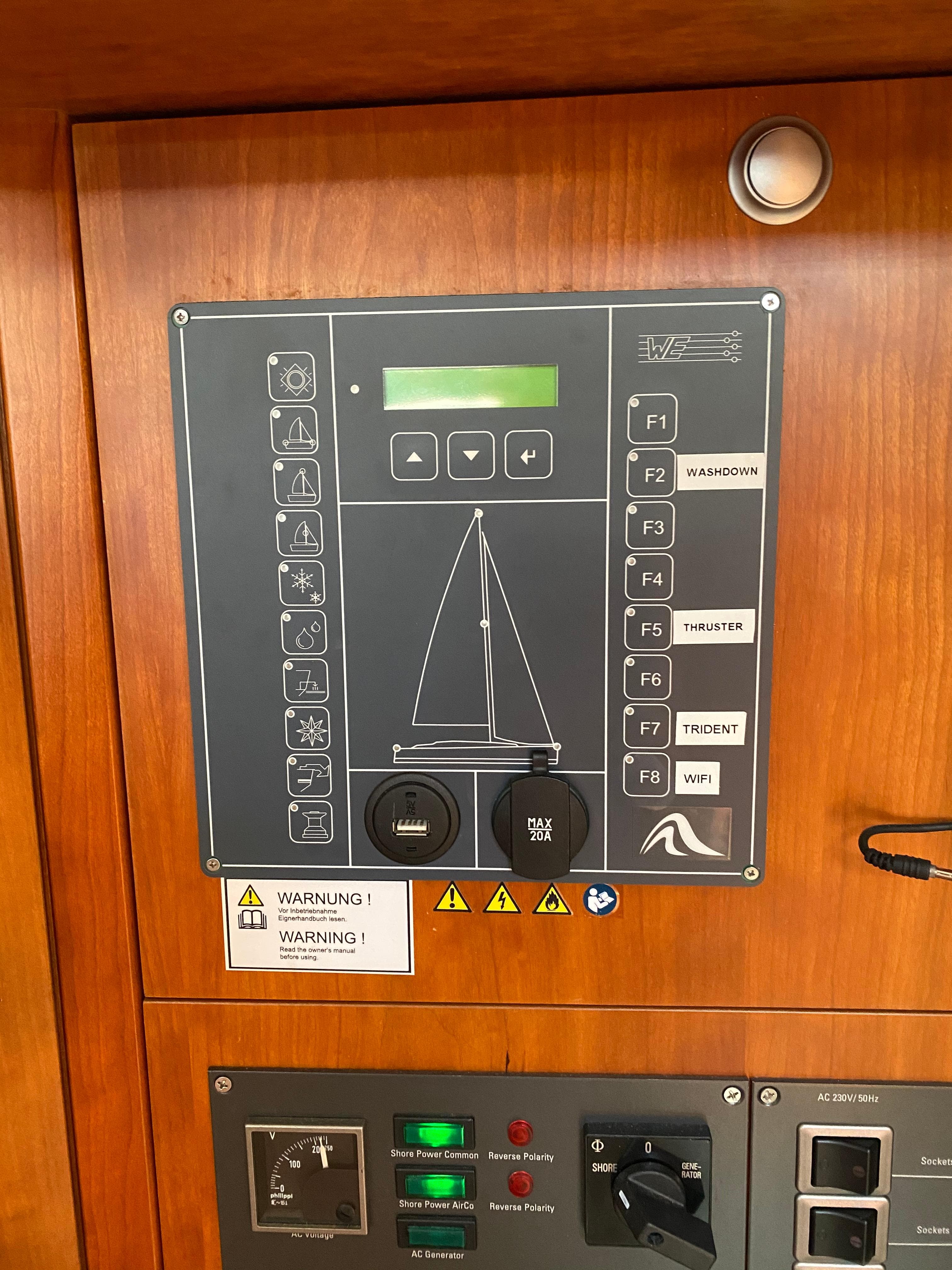 Control panel of a 2016 Hanse 505 yacht with various buttons and warning labels.