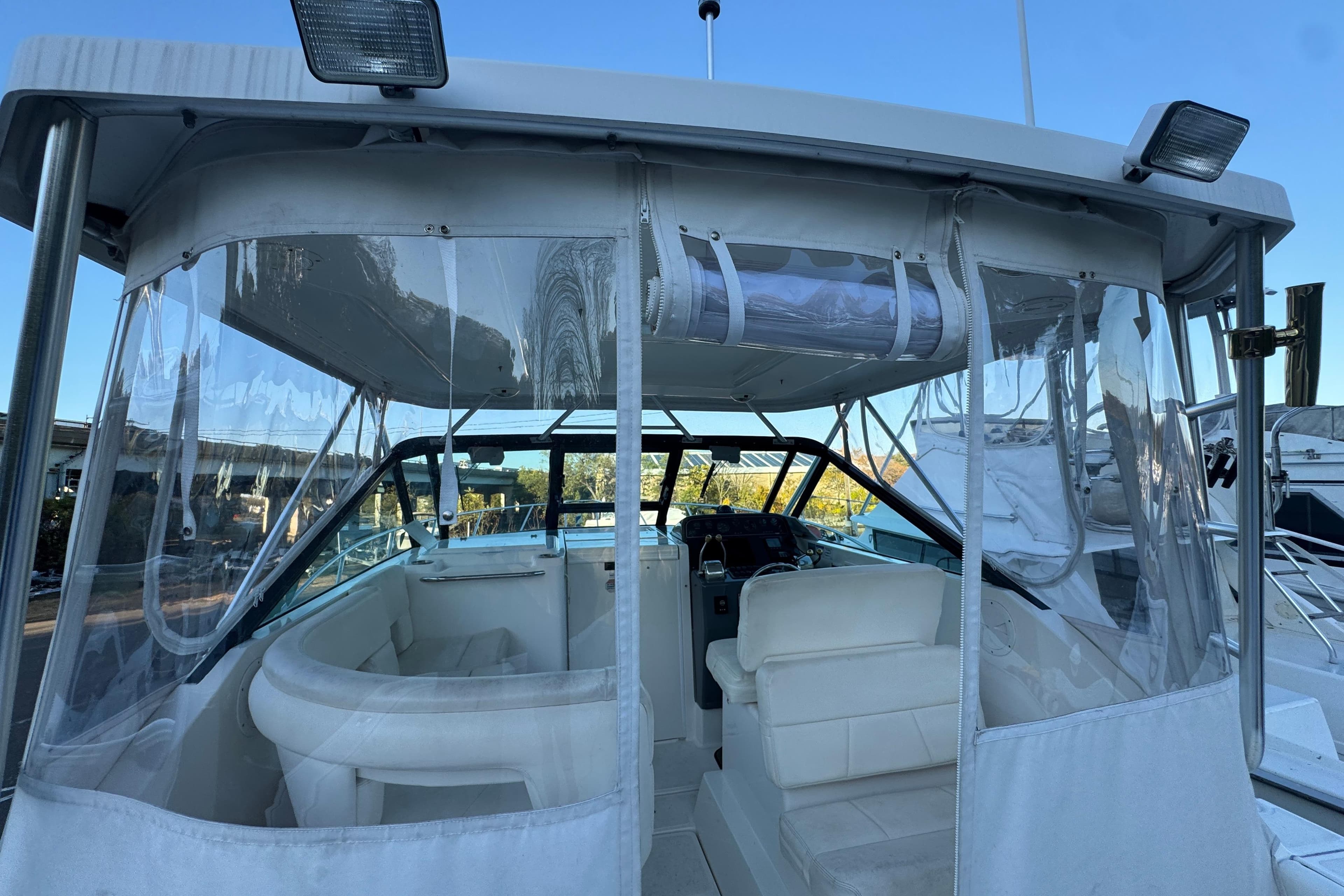 2005 Tiara Yachts 2900 Open boat interior with clear enclosures and seating.