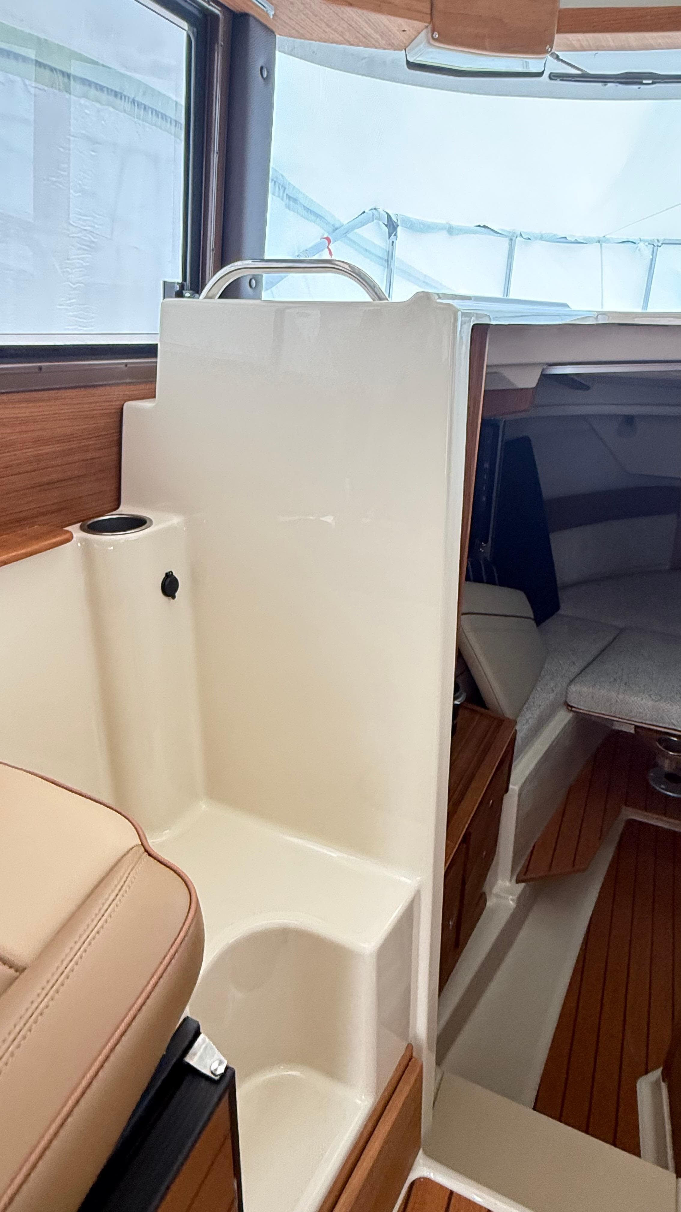 Interior of 2026 Ranger Tugs R-27 boat, featuring wood accents and seating area.