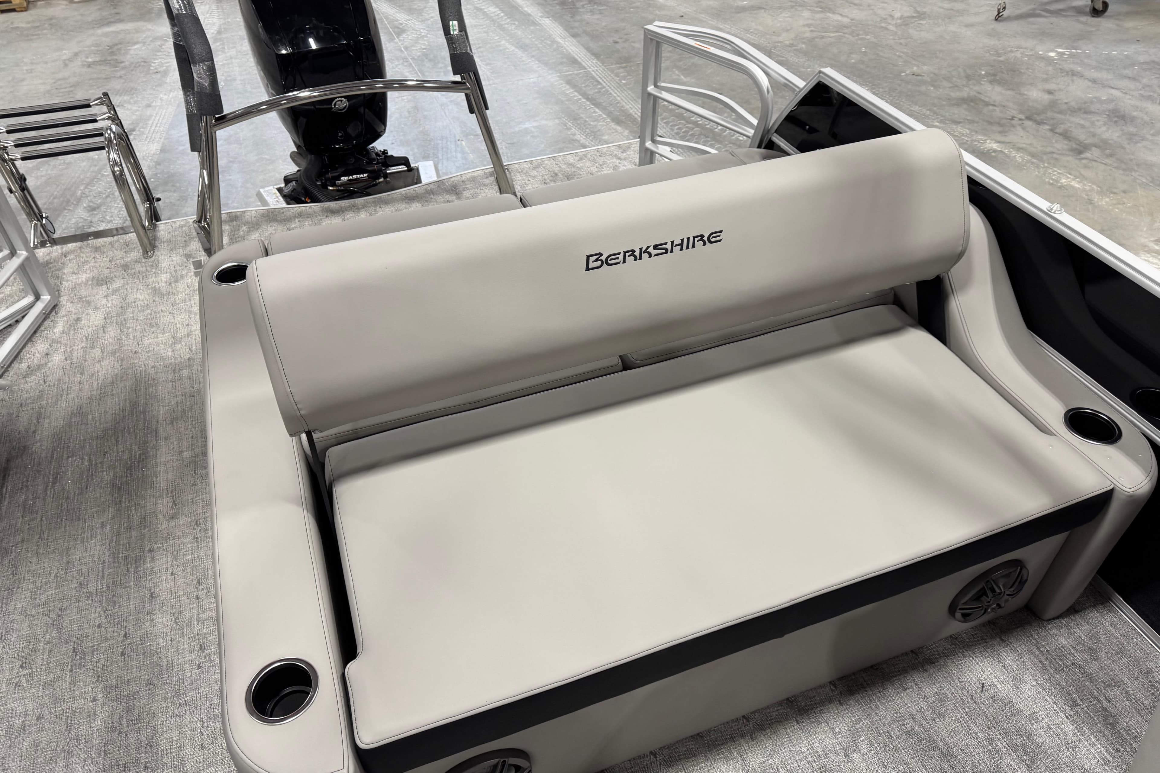 2026 Berkshire 24 UL LE boat interior with beige seating and cup holders.