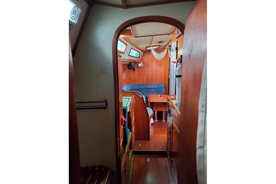 Interior of 1989 Hylas 44 sailboat with wooden furnishings and seating area.
