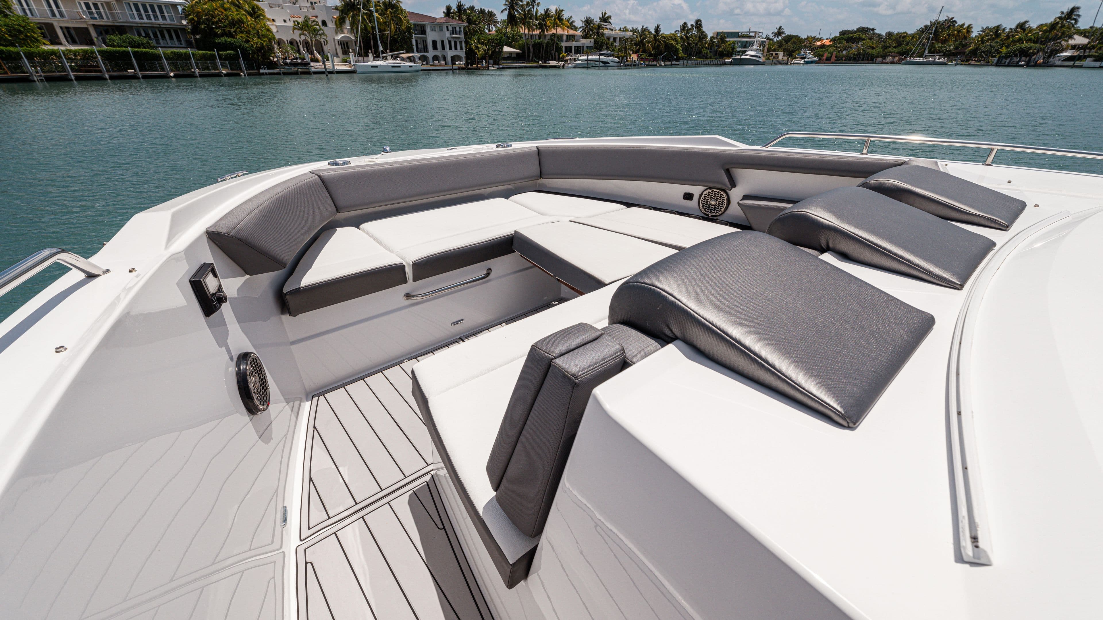 Luxurious seating area on 2020 Cruisers Yachts 38 GLS OB, overlooking serene waterfront.