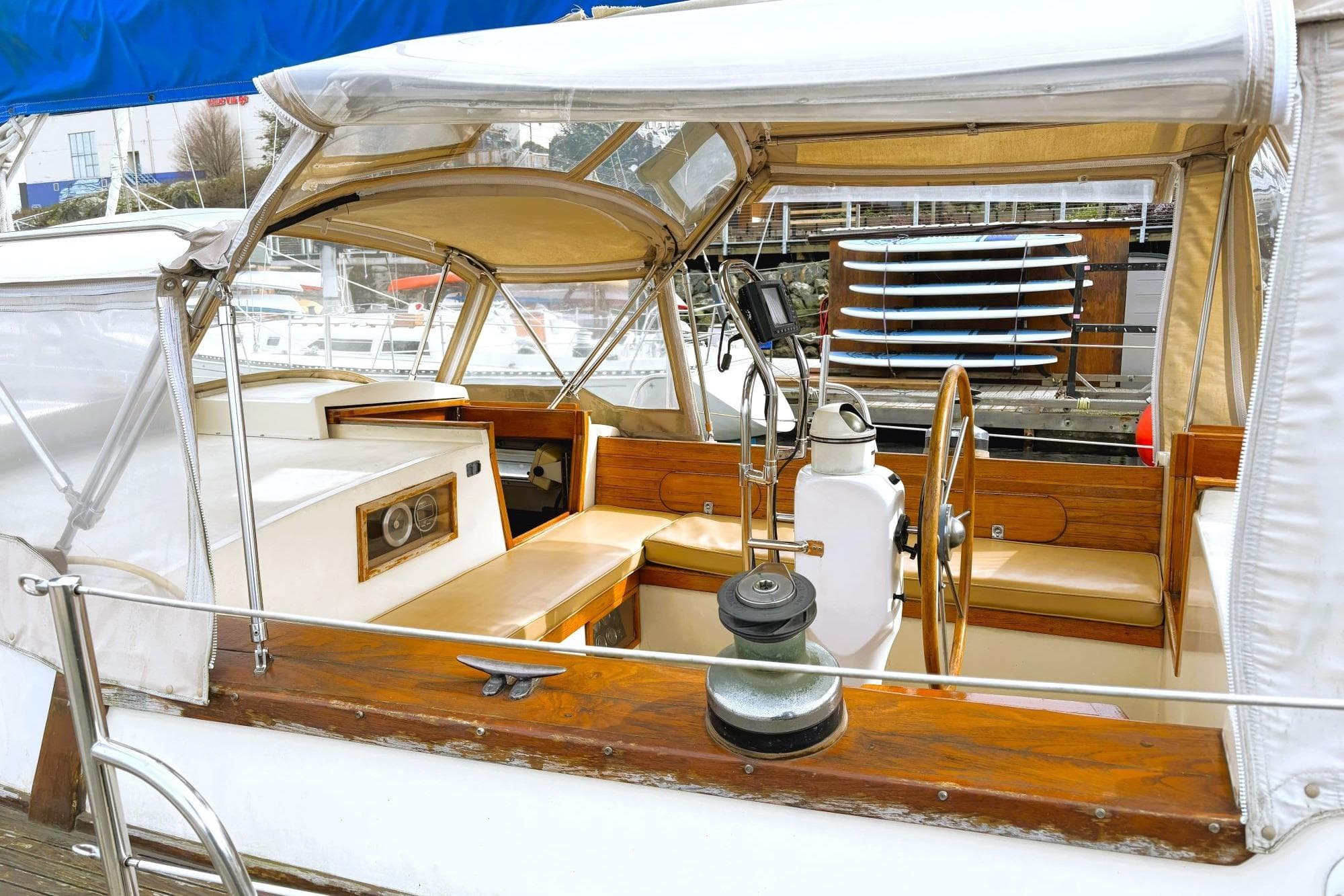 1980 Discovery 42 sailboat cockpit with wooden accents and seating at a marina.