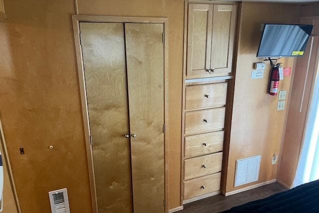 Interior of 2003 Fantasy 18x80 Houseboat with wooden cabinets and wall-mounted TV.