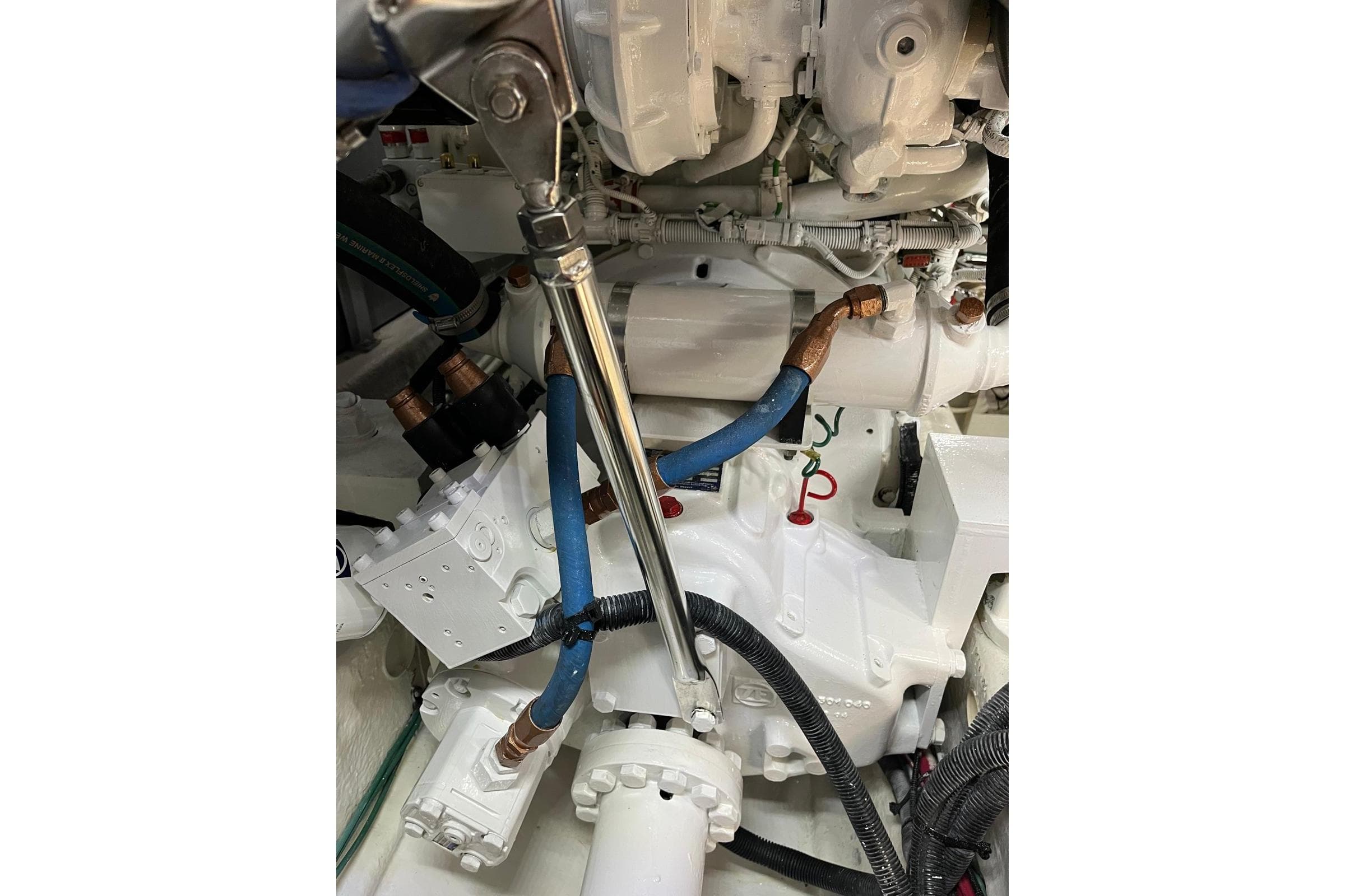 Engine compartment of a 2006 Sea Ray 52 Sedan Bridge with visible hoses and components.