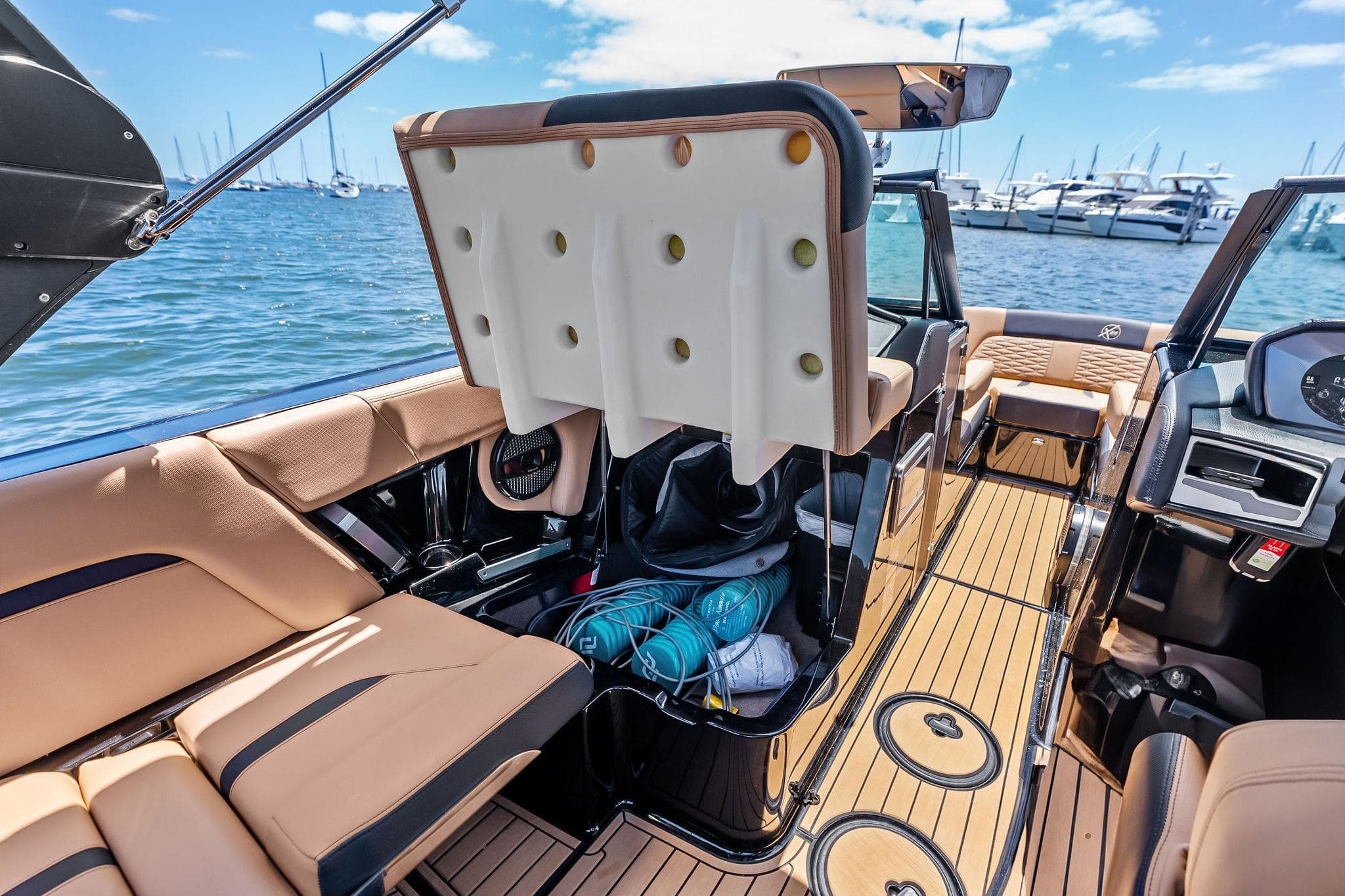2024 MasterCraft X24 boat interior with luxurious seating and modern dashboard on a sunny day.