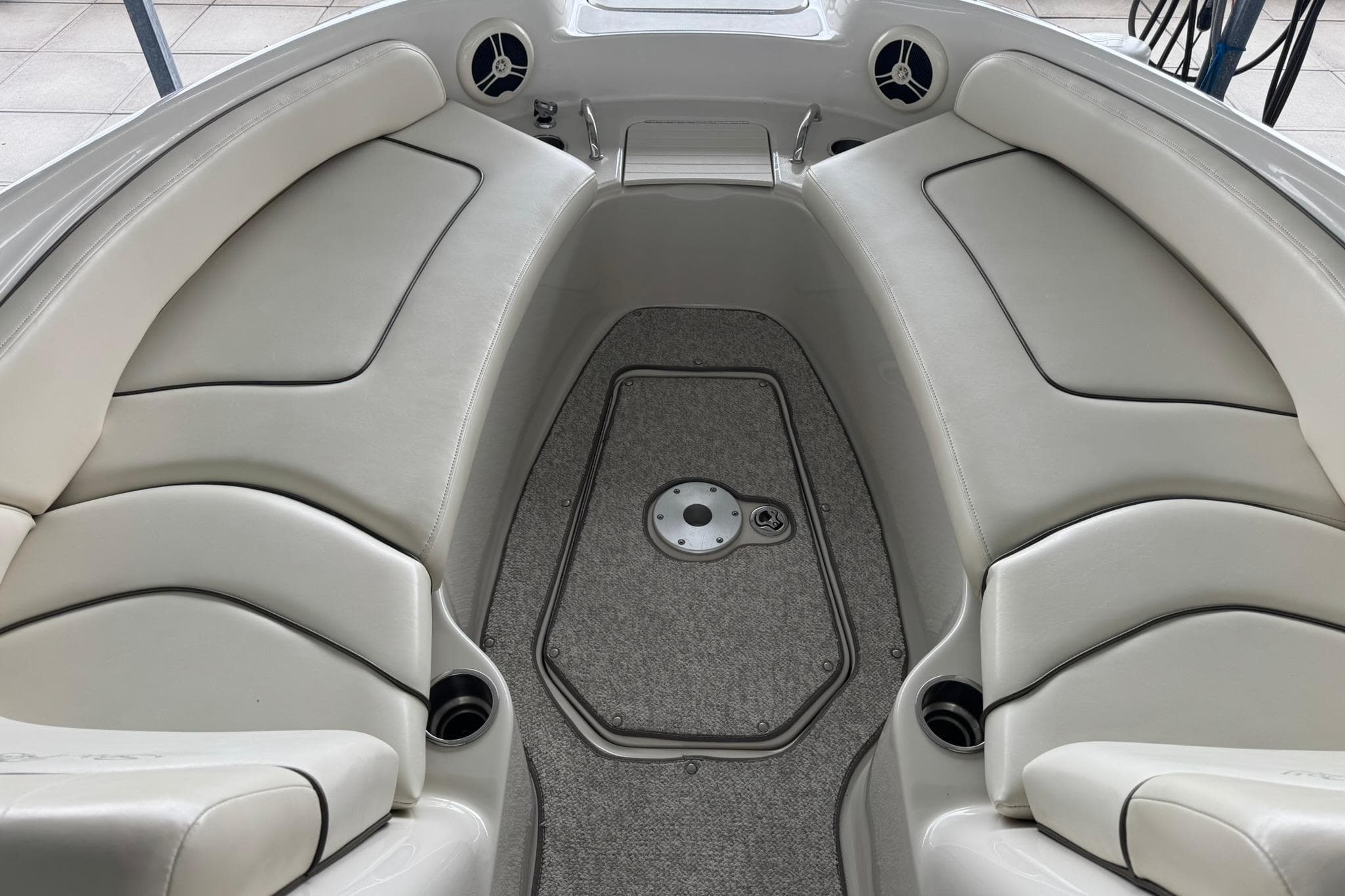 Interior view of 2008 Sea Ray 240 Sundeck boat with cushioned seating and carpeted floor.