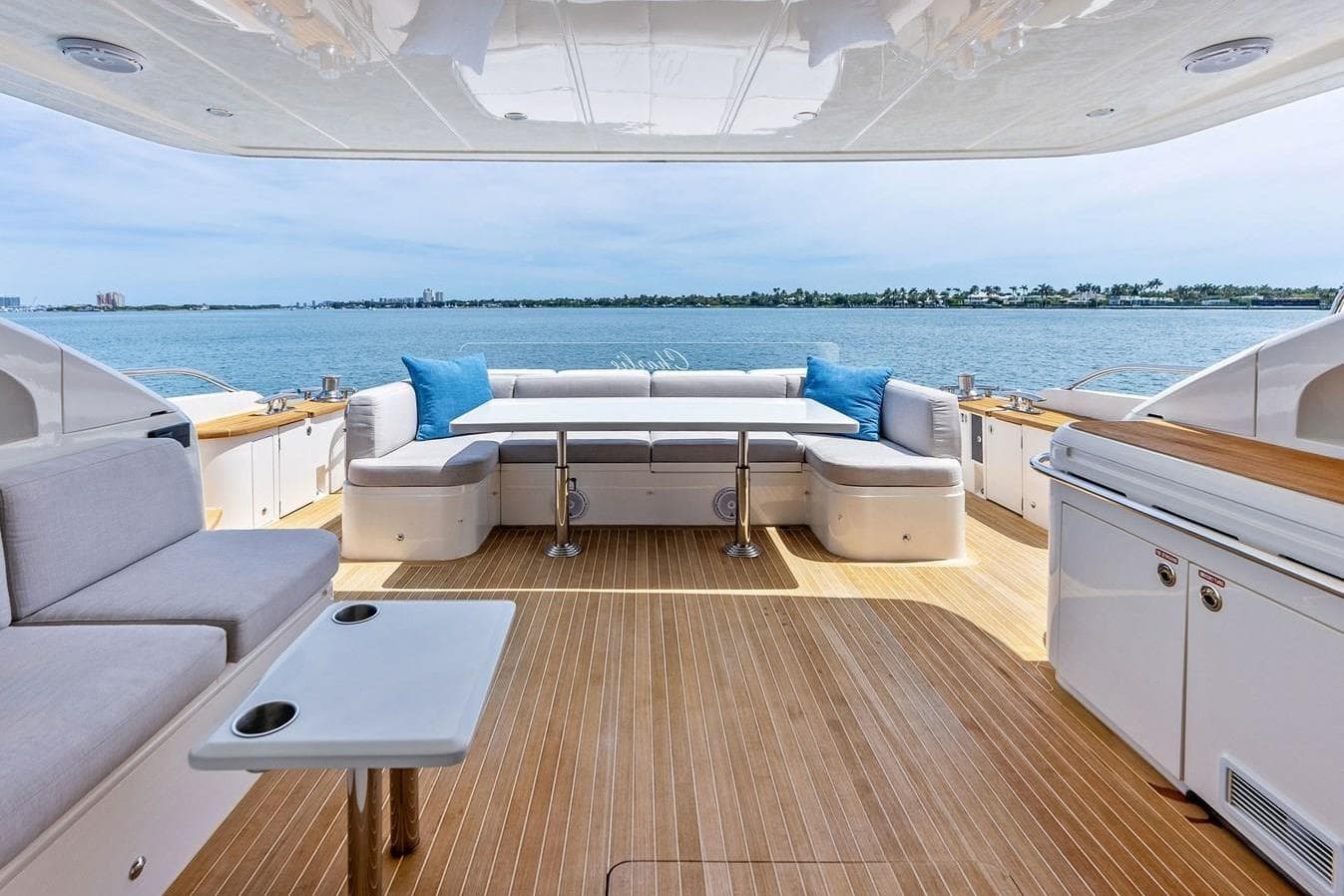 Luxurious 2013 Princess 78 yacht deck with seating, table, and ocean view.