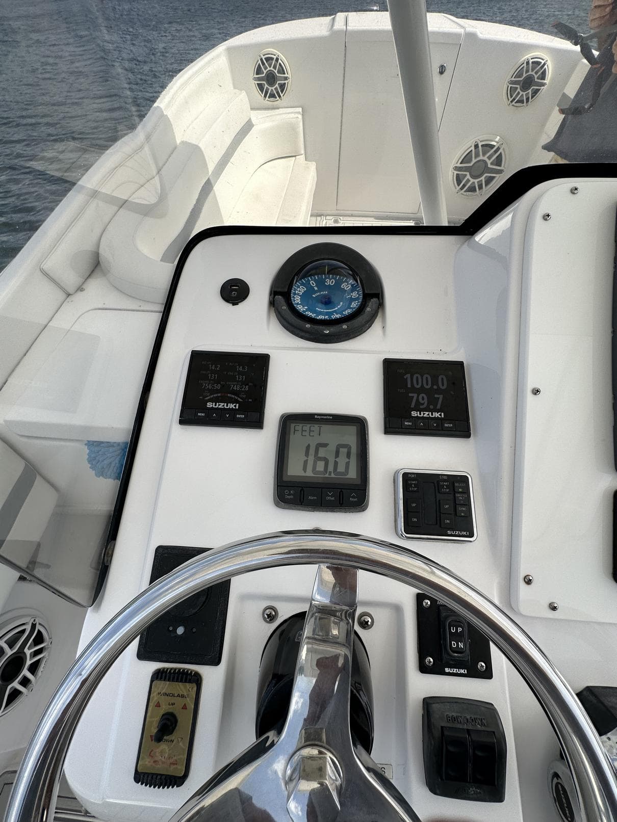 2003 Intrepid 32 boat dashboard with steering wheel and navigation instruments.
