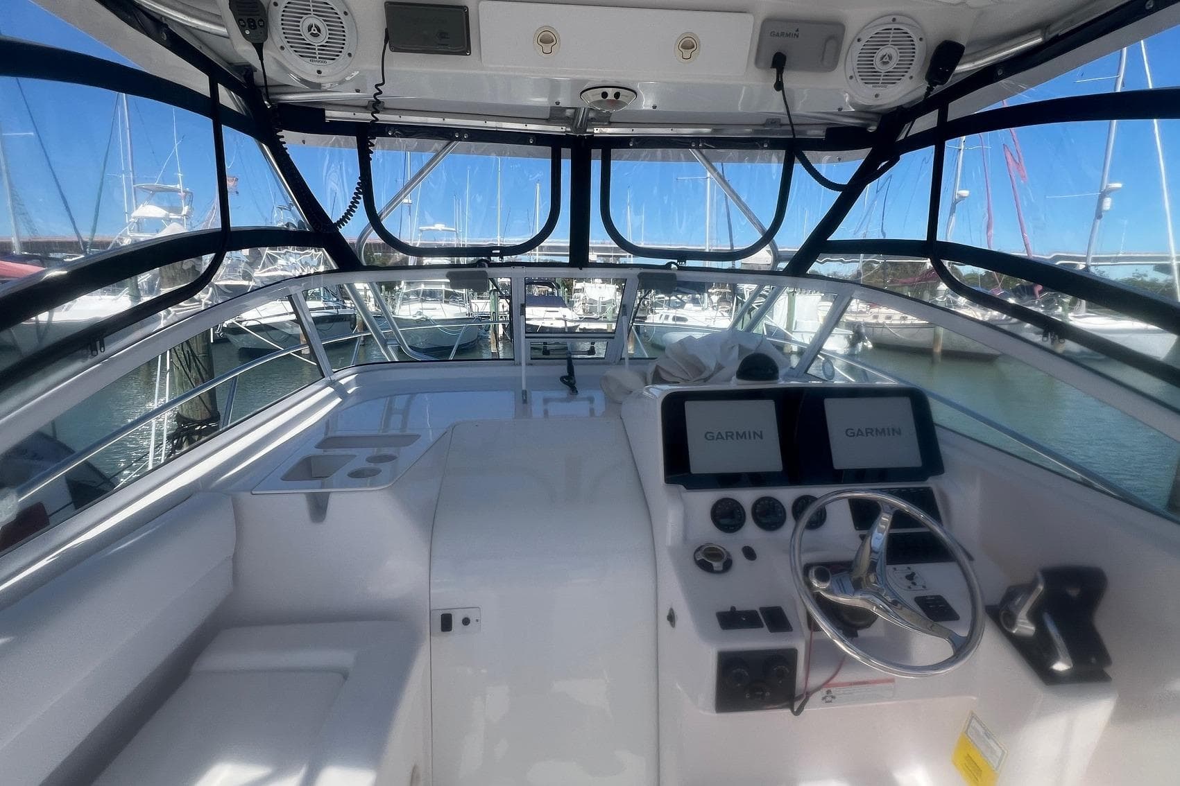 2008 Pro-Line 32 Express boat cockpit with Garmin navigation, docked in marina.