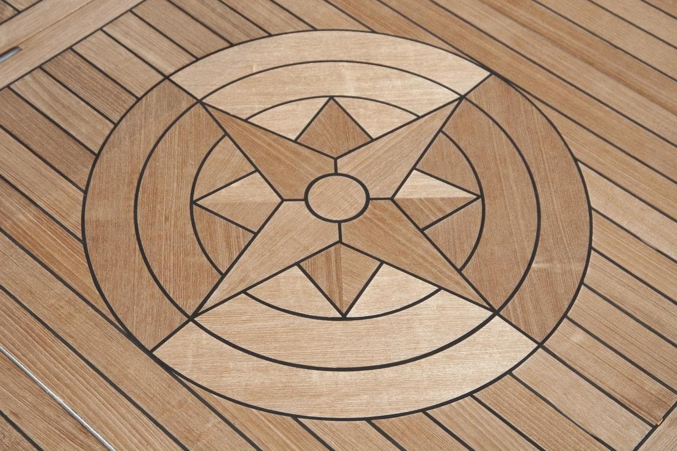 Wooden star inlay design on Custom Heisley 1995 surface, featuring geometric patterns.