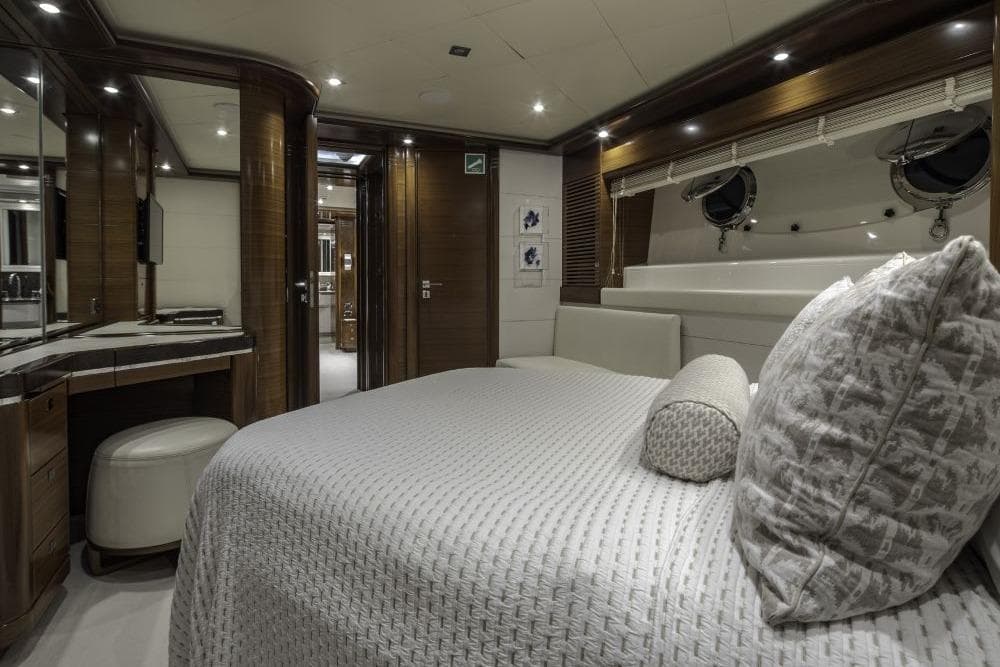 Luxurious CRN 129 yacht bedroom interior, 2009 model, featuring elegant wood finishes and plush bedding.