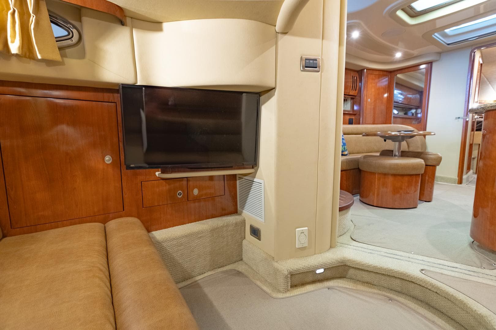 Luxurious interior of 2005 Sea Ray 420 Sundancer yacht with TV and seating area.
