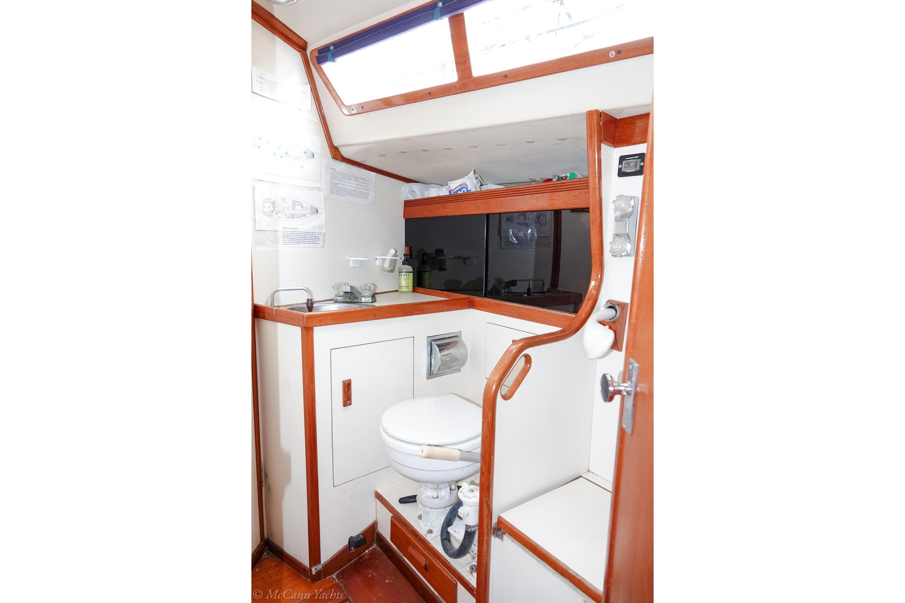 1987 Sabre 42 yacht bathroom with wooden trim and compact design.