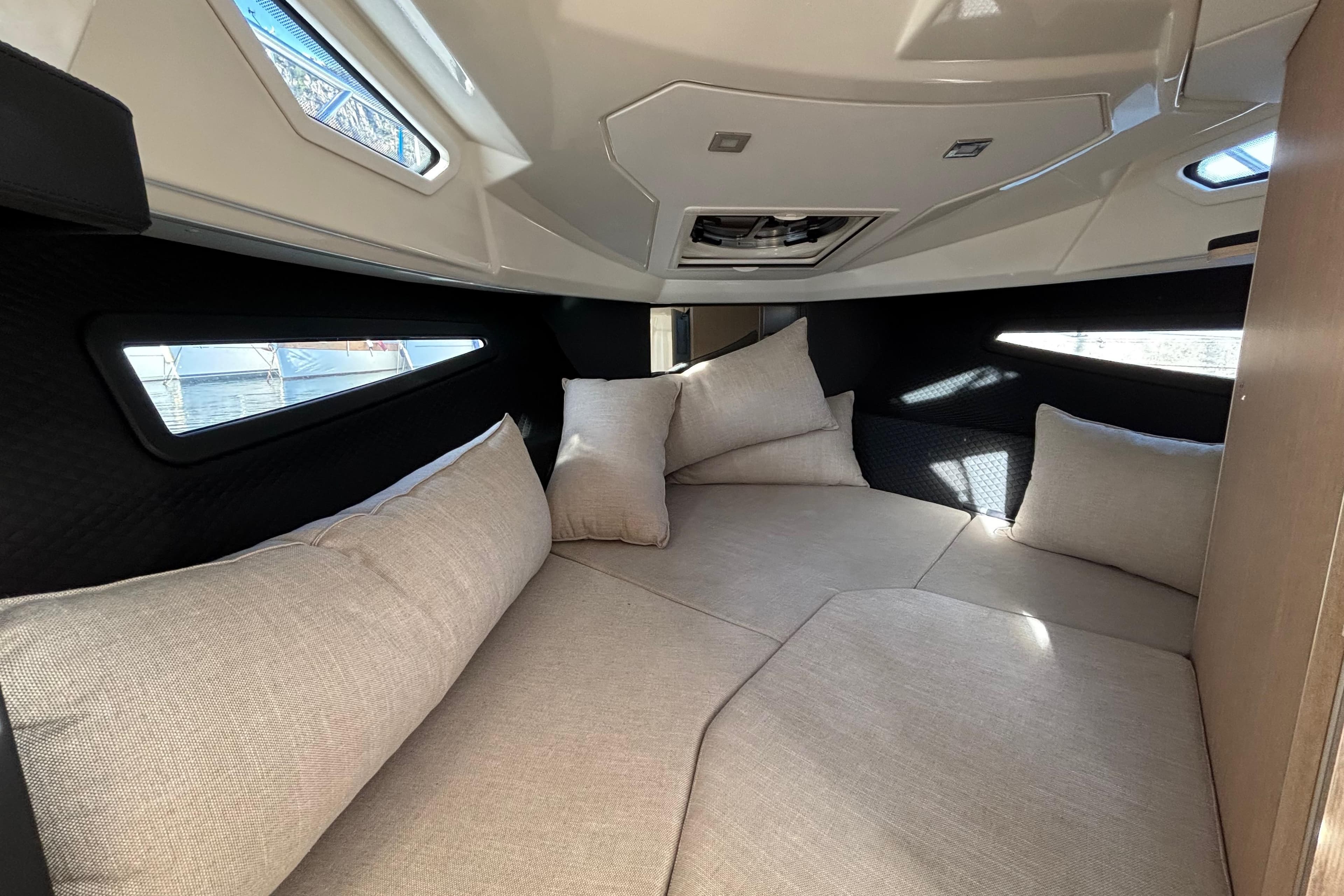 2020 Cranchi E30 Endurance cabin interior with beige cushions and modern design.