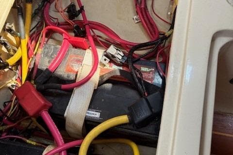 Battery compartment of 1984 Catalina 38 sailboat with wiring and connectors.