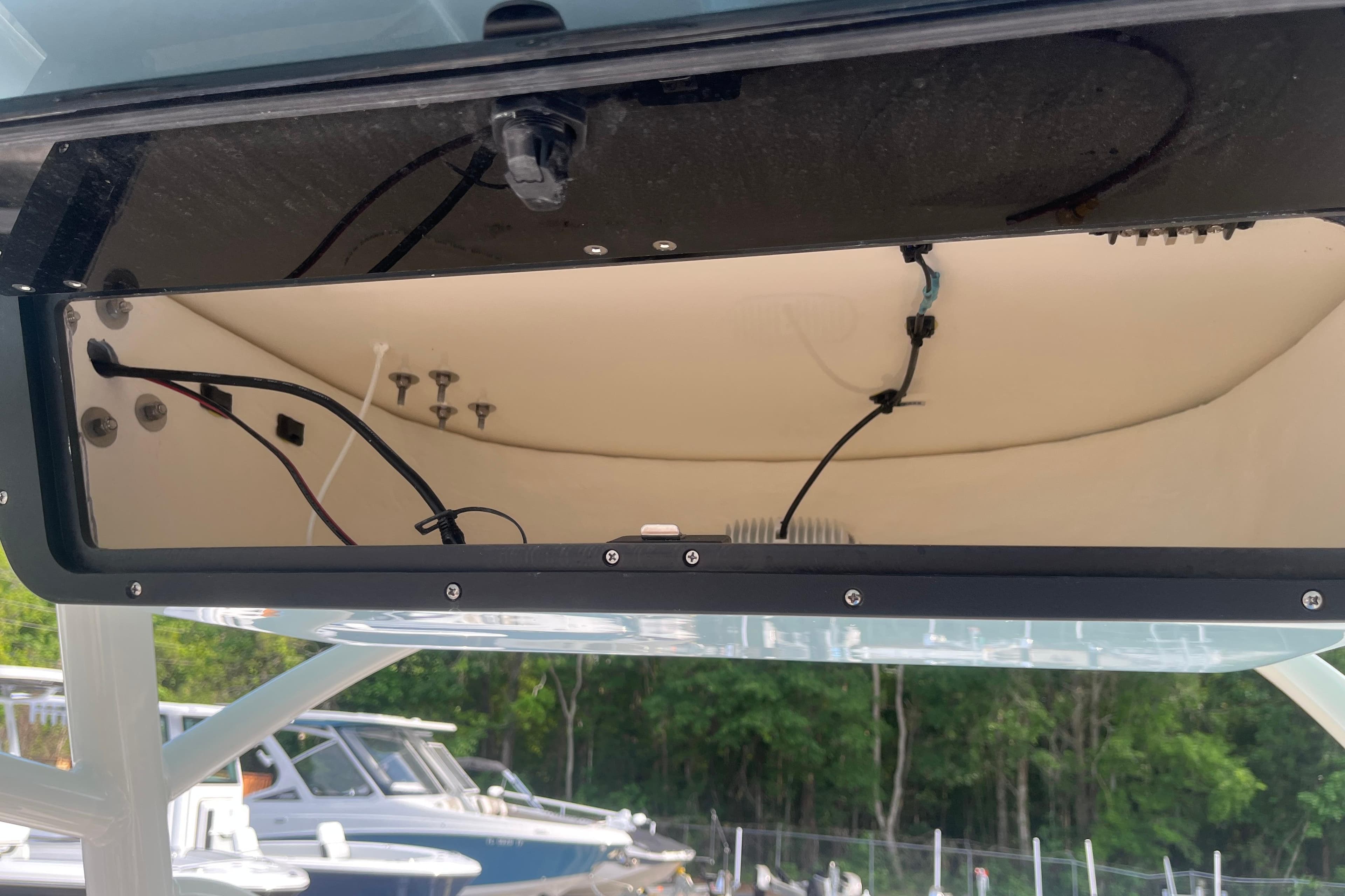Open electronics compartment of 2026 Pioneer 222 Islander boat, showing wiring and components.